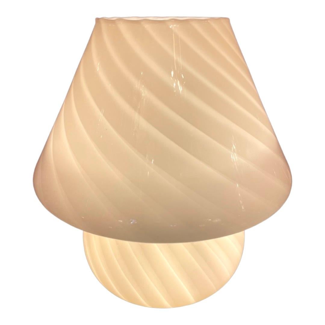 Handblown vintage Murano glass table lamps handmade in Italy, 1970s.

The Lamp is one whole piece including the shade.
Very slight blush pink colour with clear/off white swirl detailing.
Immaculate condition.
The lamps give off a beautiful warm