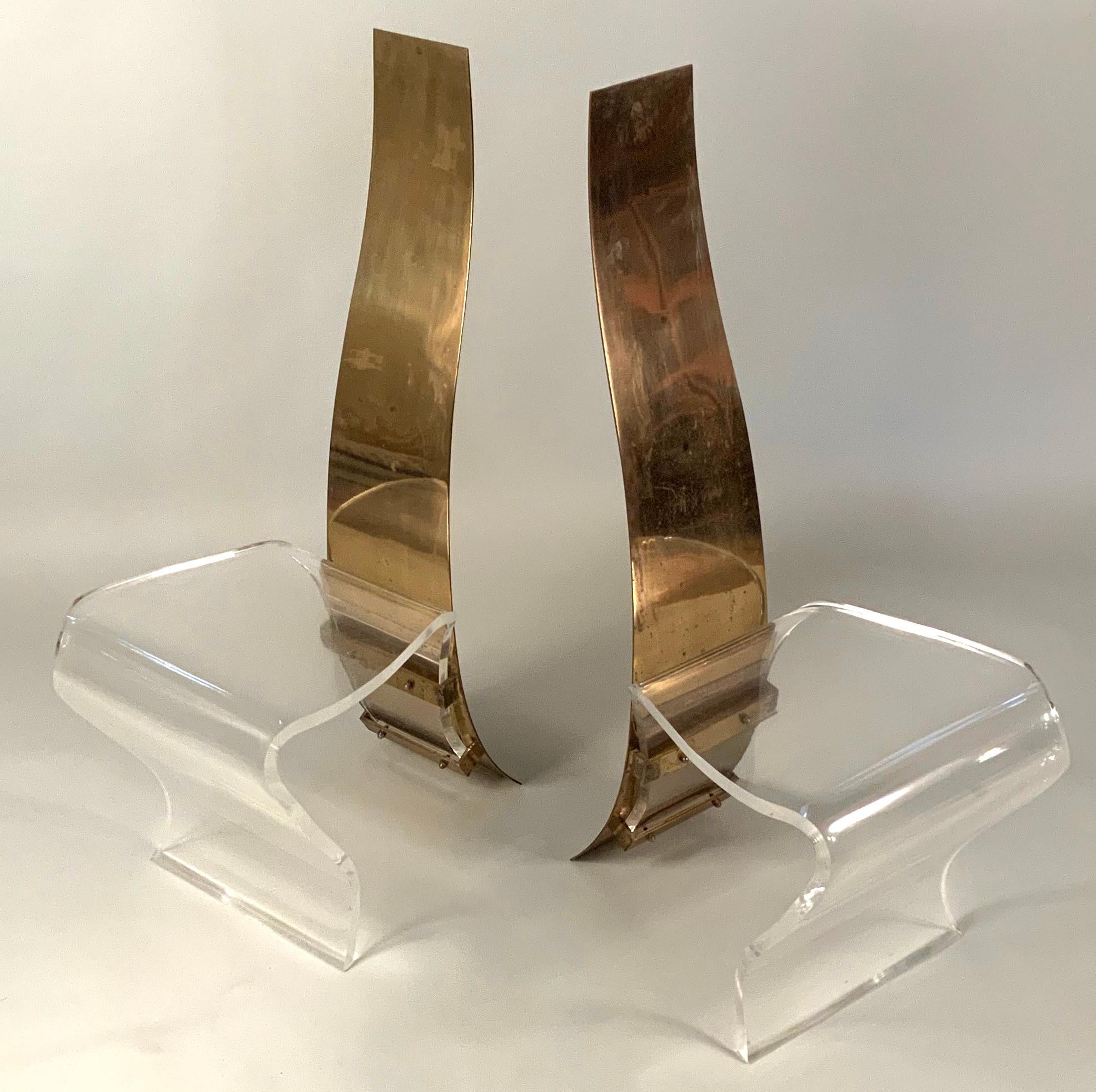 A very well made pair of vintage 1970s side chairs with frames in curved brass with polished stainless curved spines. The seats in very thick and substantial curved Lucite. Wonderful design and scale and proportions, and very comfortable. The