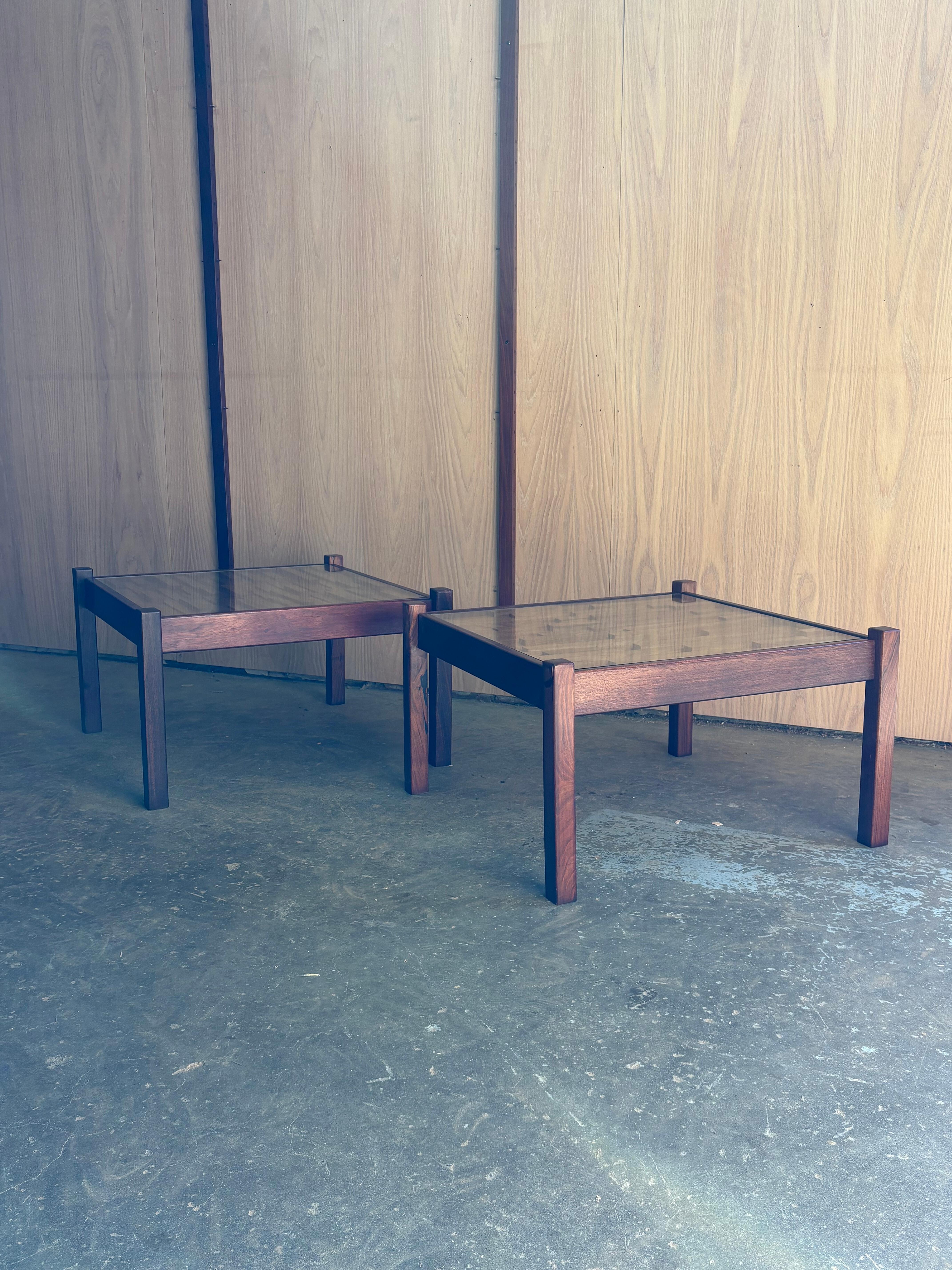 Pair of 1970s Brazilian hardwood side tables by the celebrated Percival Lafer, each showcasing his signature geometric mosaic tops beneath smooth glass. Freshly cleaned and polished by our team, the warm tropical hardwood frames glow with rich color