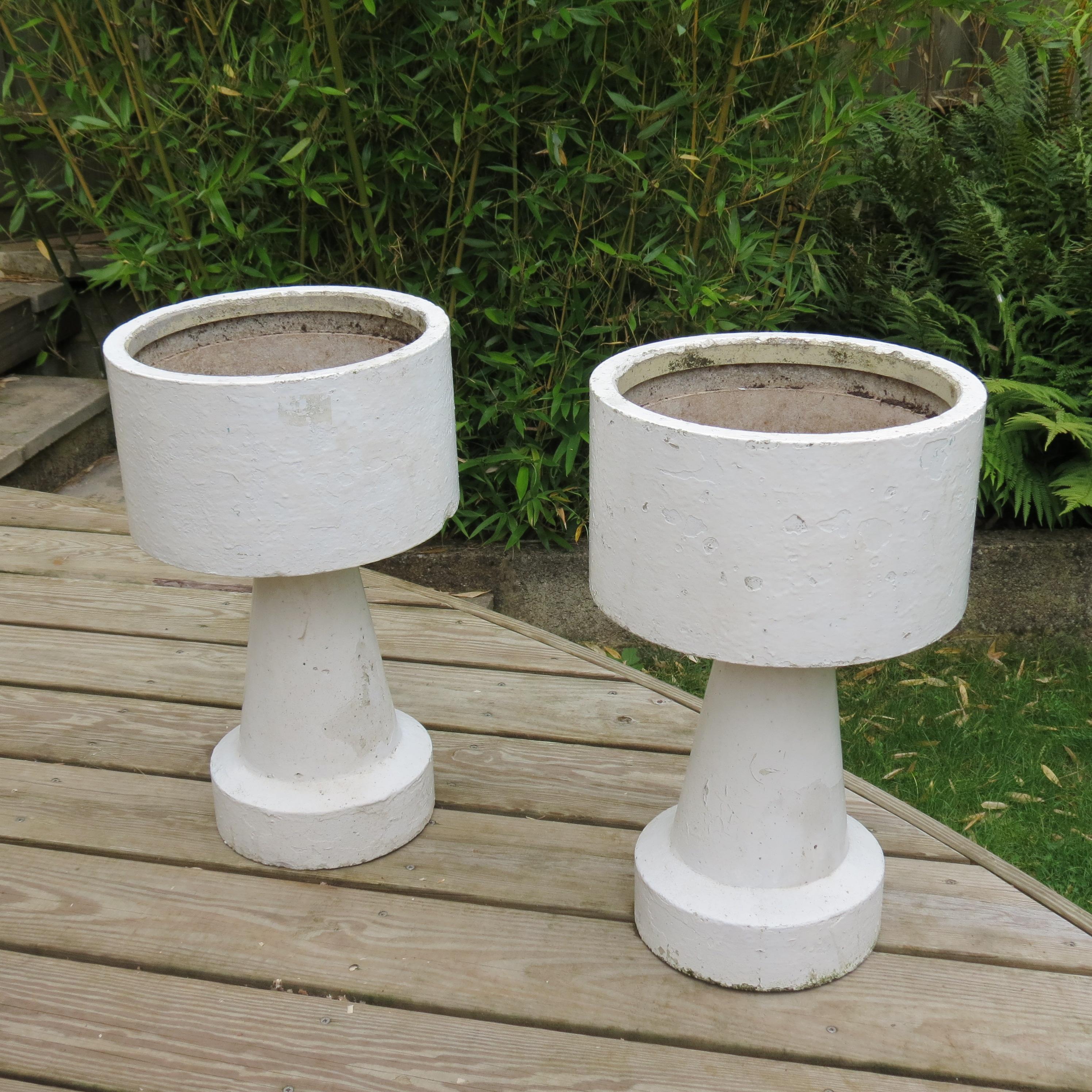 Pair of Brutalist style concrete planters from the 1970s. Made from concrete, painted white, they have been overpainted many times over the years to give a great layered effect. In good solid condition with patination to the finish. The planter bowl