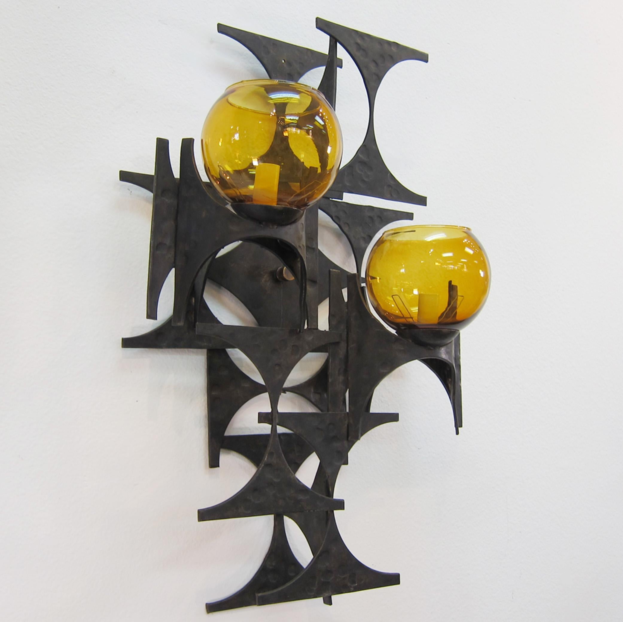 A pair of 1960s steel brutalist sconces with amber glass globes. Very sculptural with a large scale.