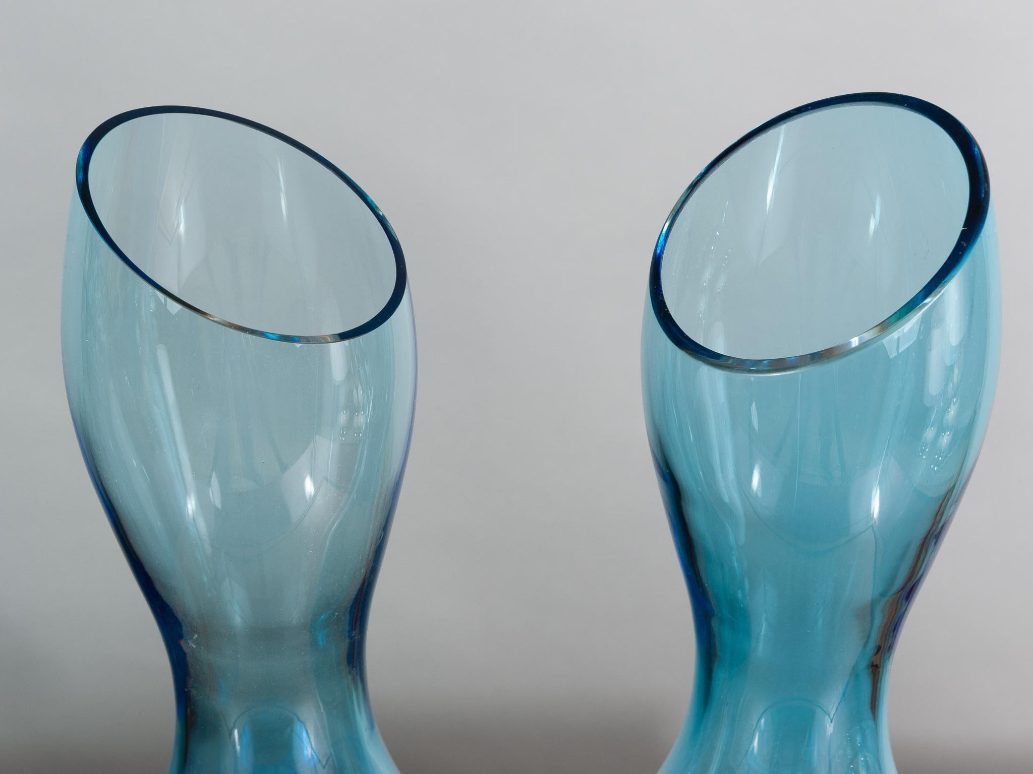 An interesting pair of 1970s bulbous Rosenthal turquoise vases. The vases are an exact pair in design and color but it is worth noting that one is slightly thicker than the other and half a centimetre smaller in height. Stamped with the makers mark