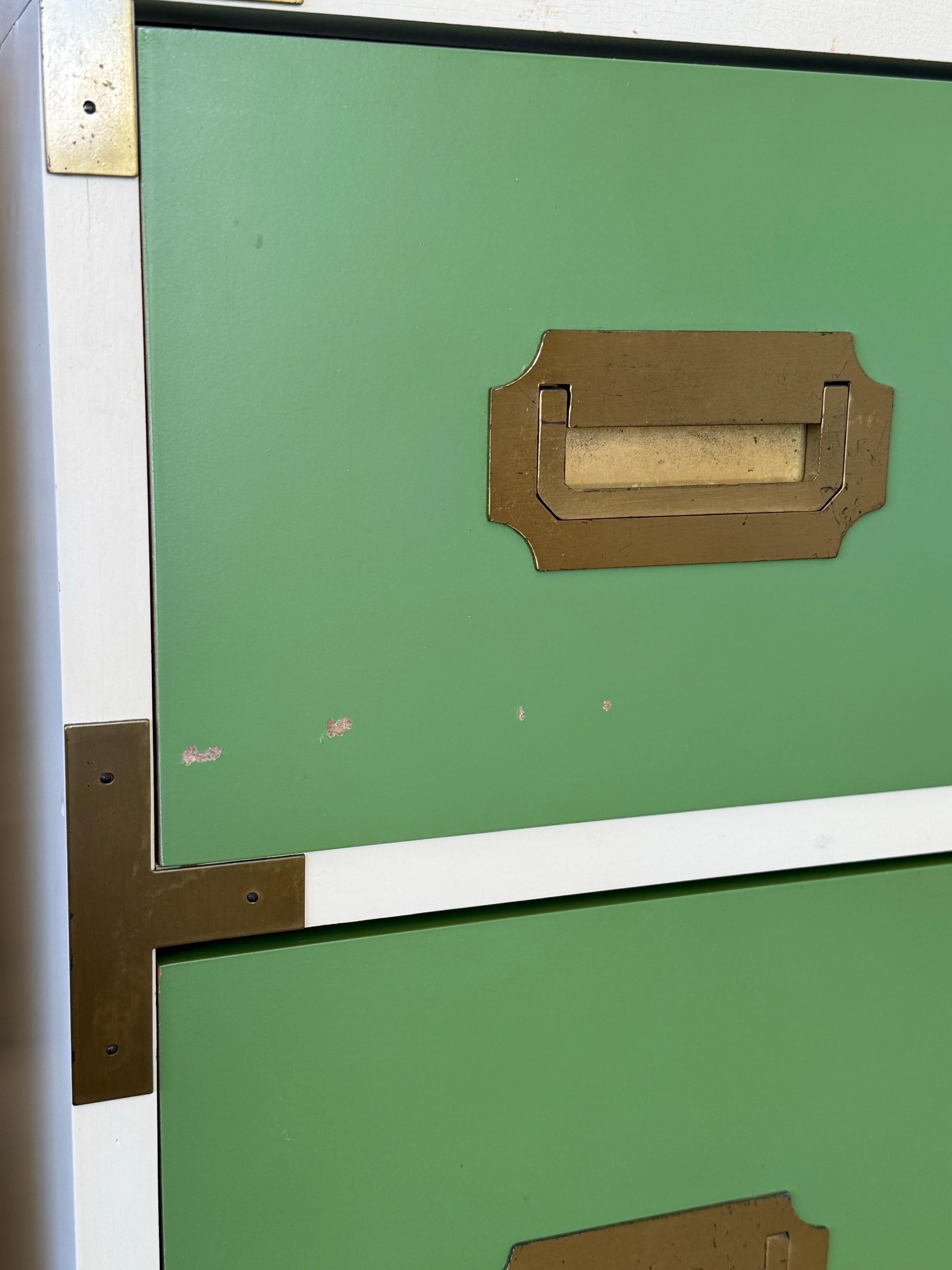 Step back into the 70s with this groovy pair of Campaign-style bachelor chests from the “Swingers Collection” by Schoolfield Industries.
Featuring bold green and white laminate with brass hardware, these pieces bring vintage charm with a playful
