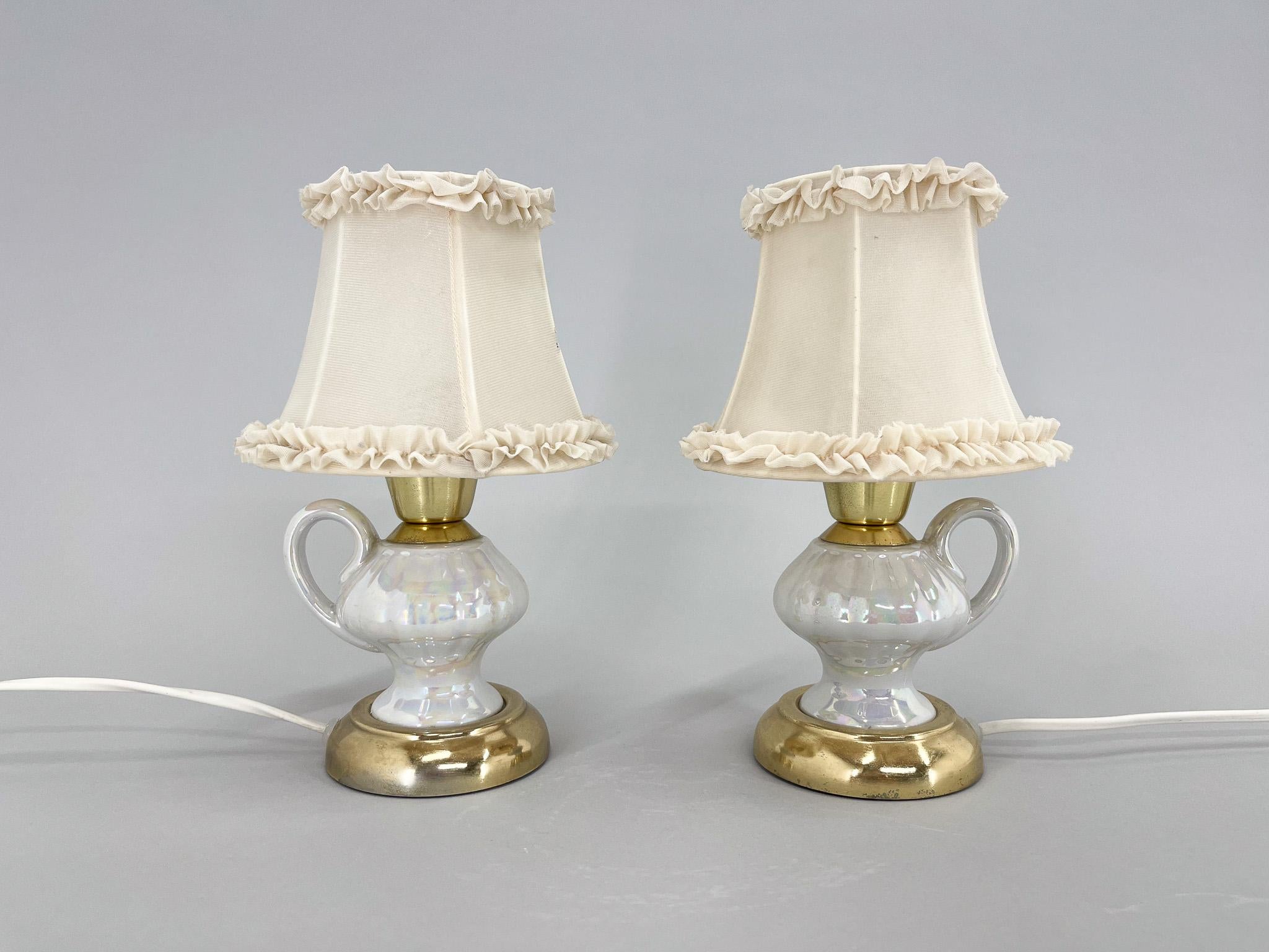 Vintage unusual bedside or table lamps made of ceramic in the shape of a tea cup, metal and fabric lamp shade. Original, fully functional wiring.