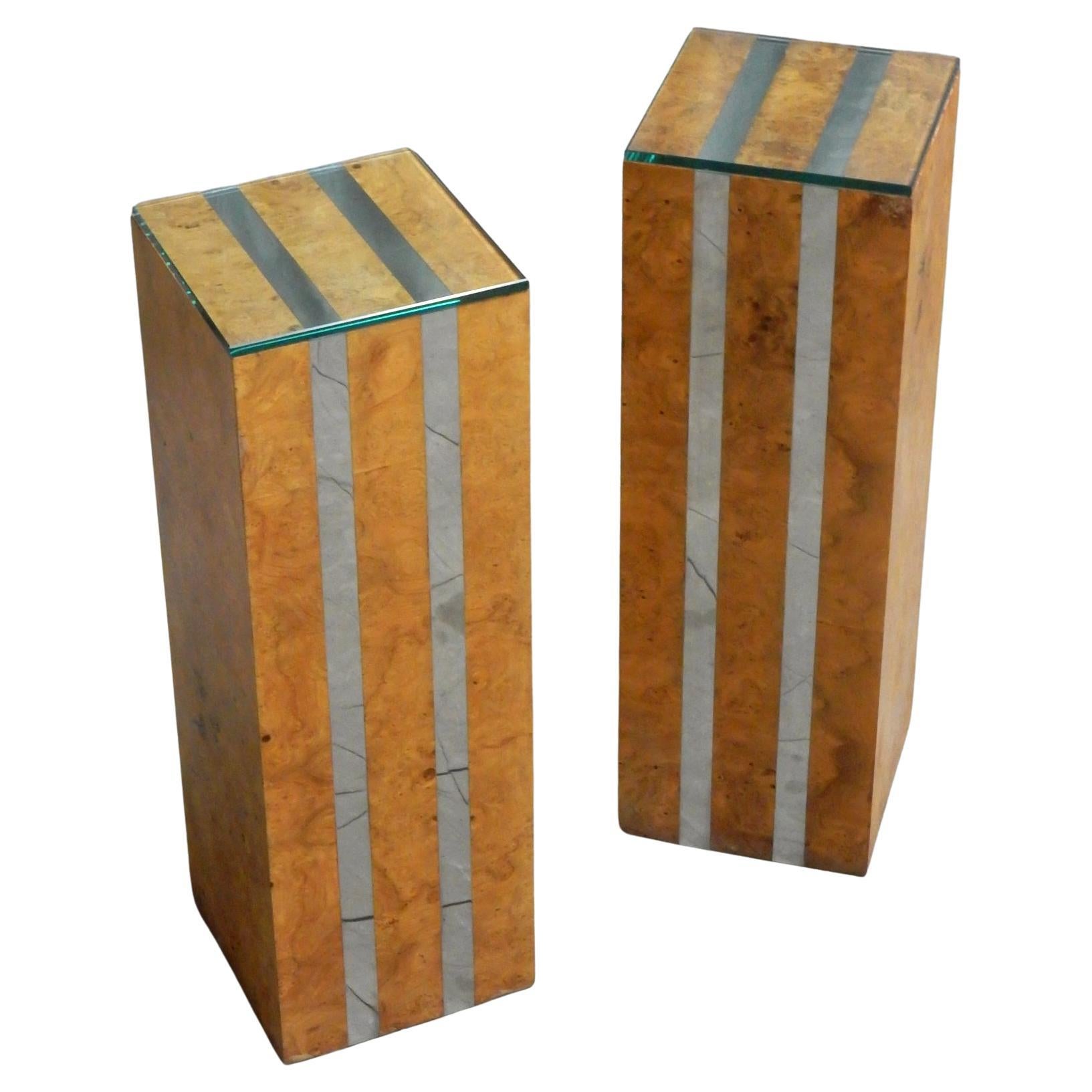 Wooden pedestals with patchwork Olive burl wood veneer with a pair of chrome steel stripes. 1/2 inch glass tops. Circa 1970's .
A few top and bottom edge wear in veneer with filler patch. Please see pictures.
Nothing detracts.