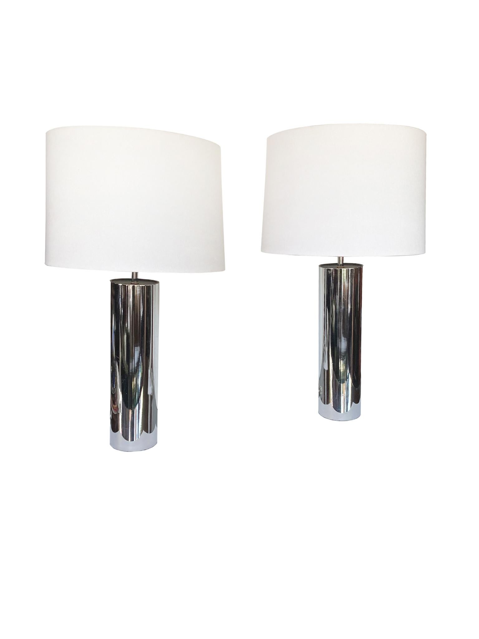 A pair of chrome table lamps attributed to the designer George Kovacs. We love the simplicity of these cylinder lamps. While their shape may seem basic, their high lustrous turns up the design. These are a classic.

The lamps are newly rewired