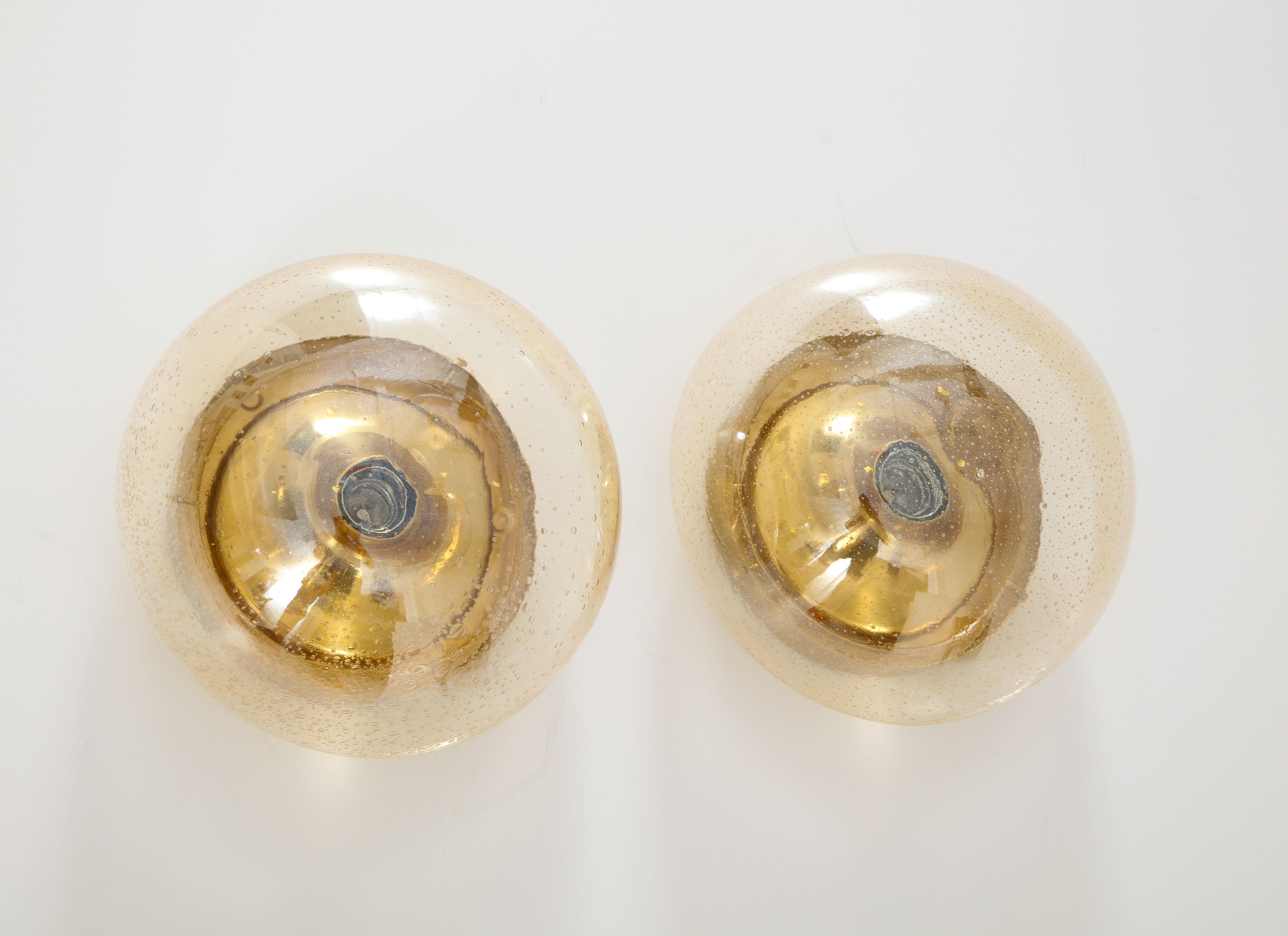 Pair of 1970's Murano glass dome sconces / flush mounts by Limburg.
The glass dome fits onto a brass back plate with a single light source
That has been Newly rewired for the US.