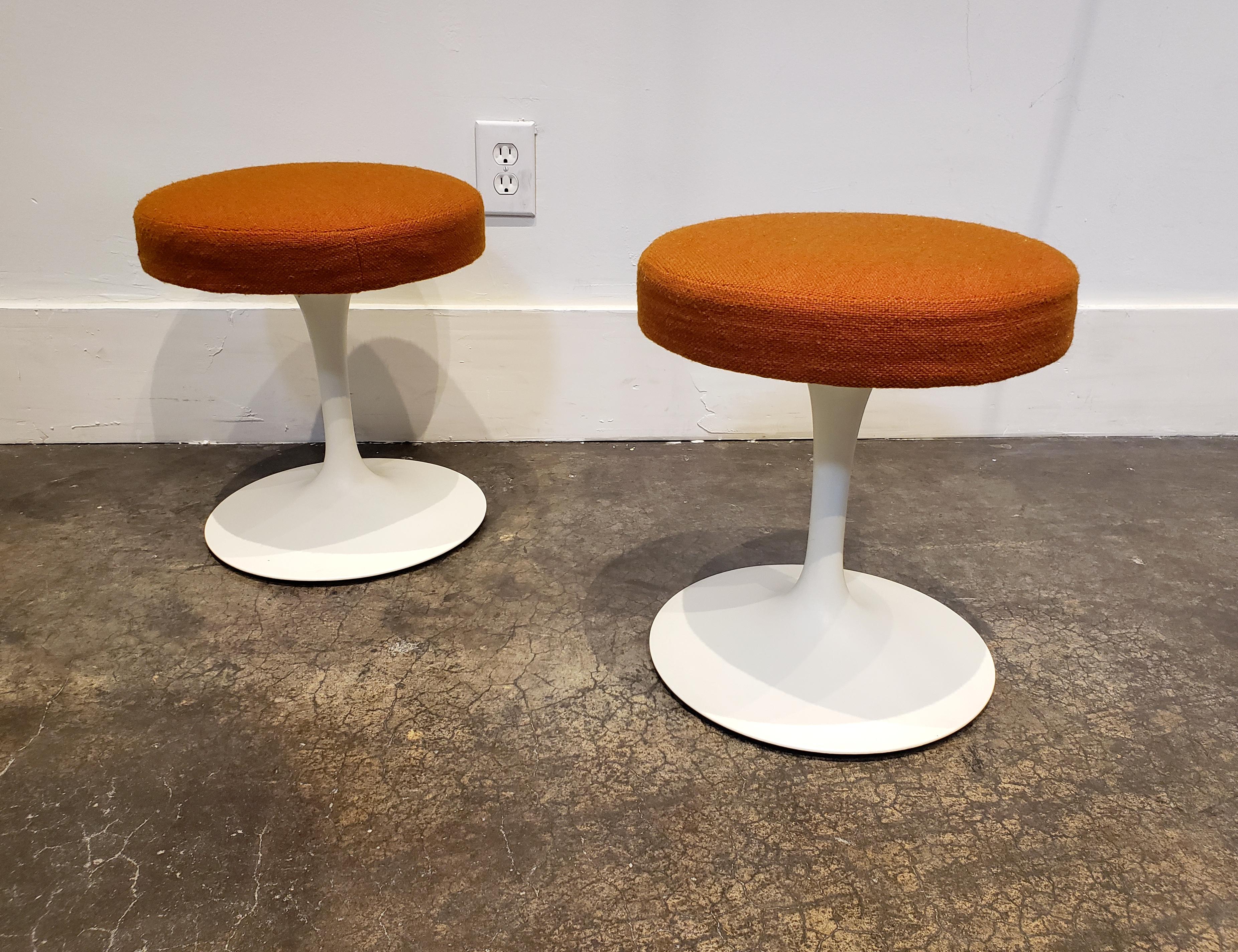 Pair of early 1970s Knoll Tulip stools designed by Eero Saarinen. In amazing condition! Original wool-blend fabric and aluminum base both have only very light wear. Original labels are still attached (see pictures). Both are clean and ready to use.