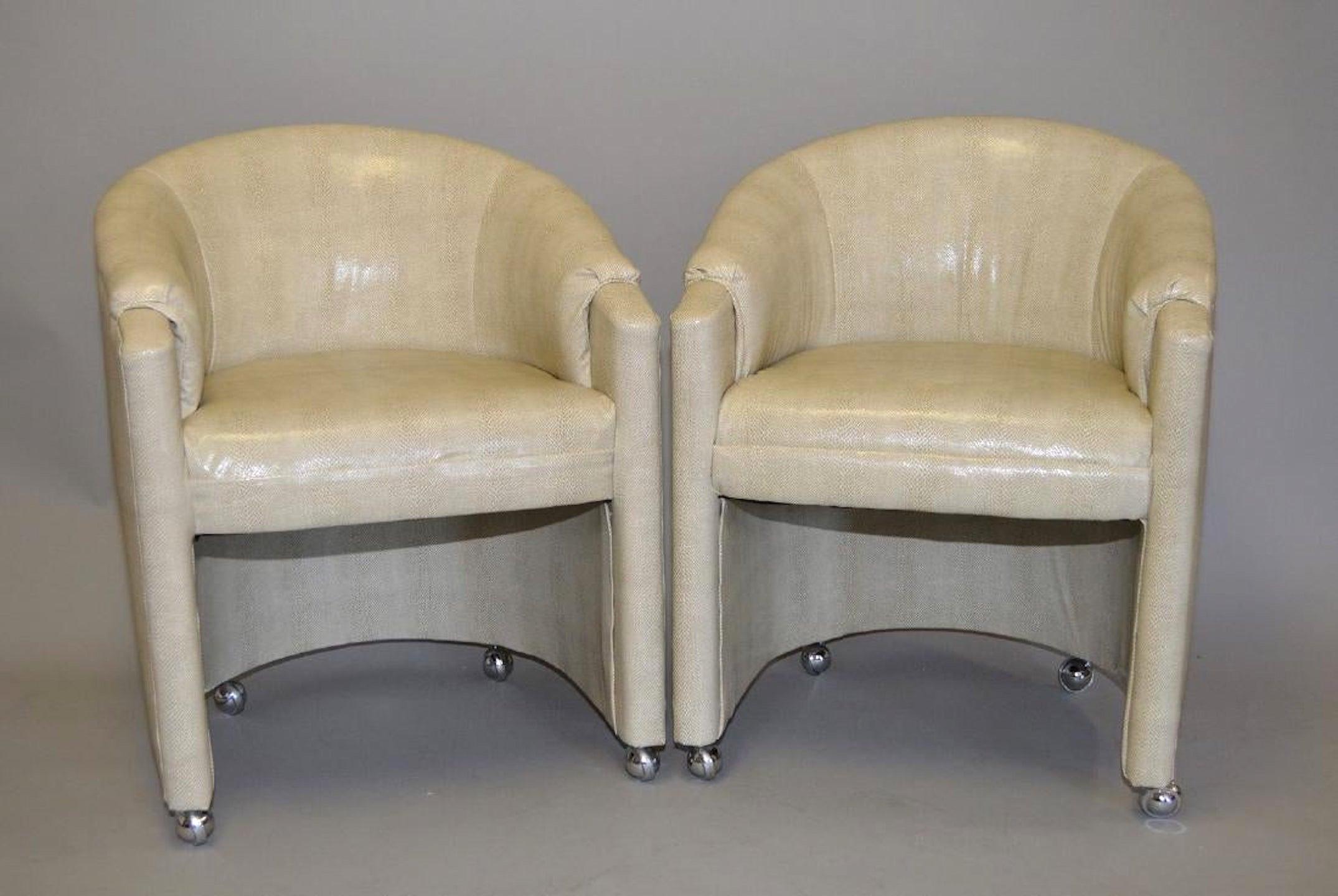 Pair of 1970s faux snakeskin rolling club chairs, each one with custom upholstery.
   