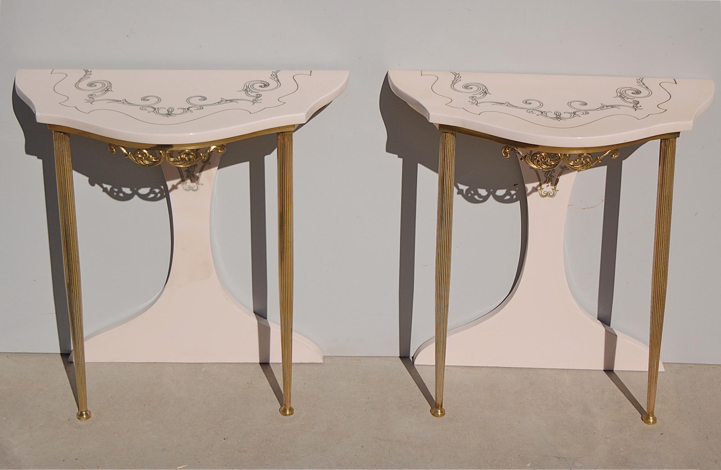 This pair of Italian night tables or nightstands bear style elements reminiscent of the playful design of Piero Fornasetti. The neoclassical, brass tapered legs and scroll design are combined with a retro 1970s laminate tabletop and rear panel