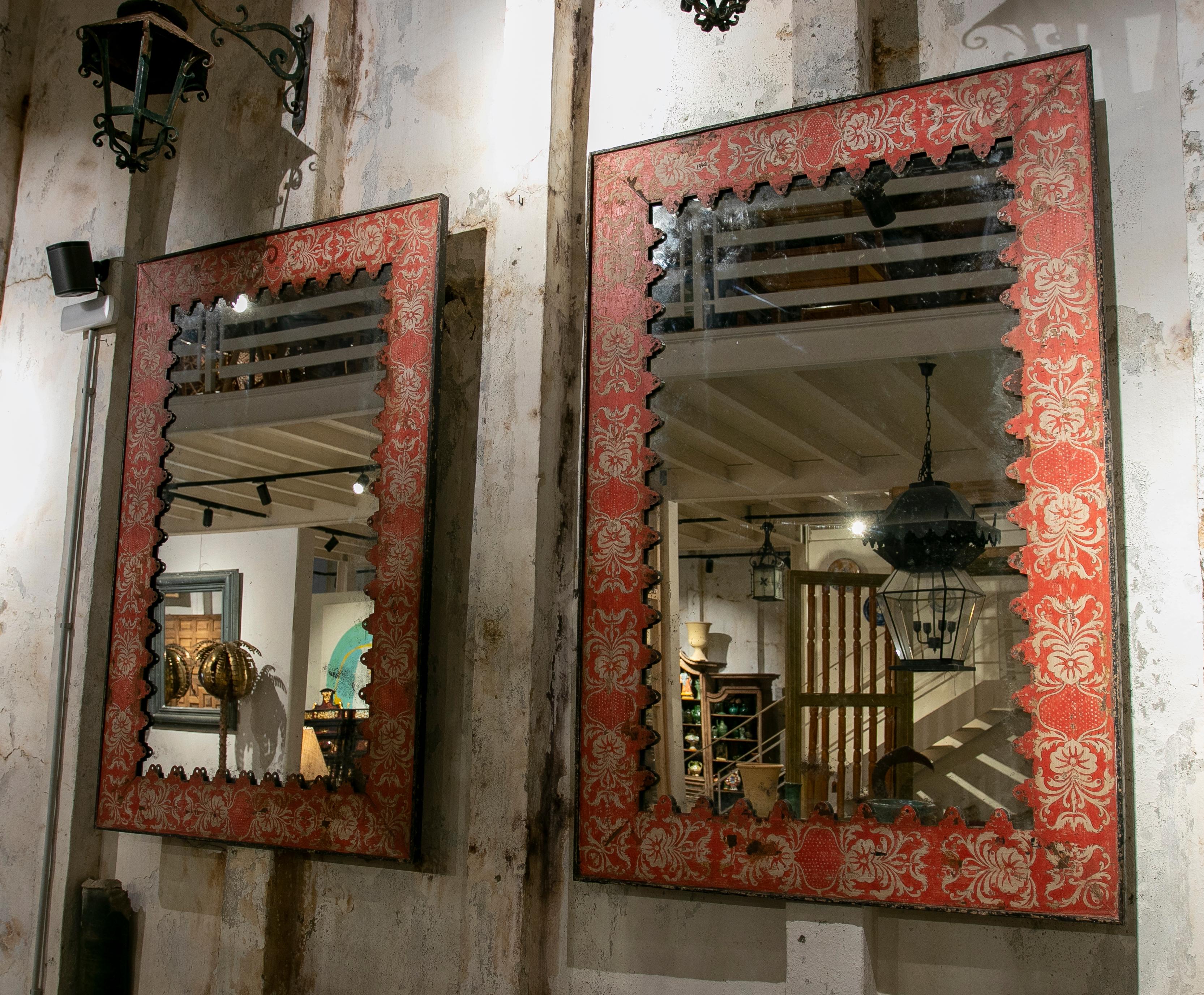 Pair of 1970s French painted iron wall mirrors in red color.