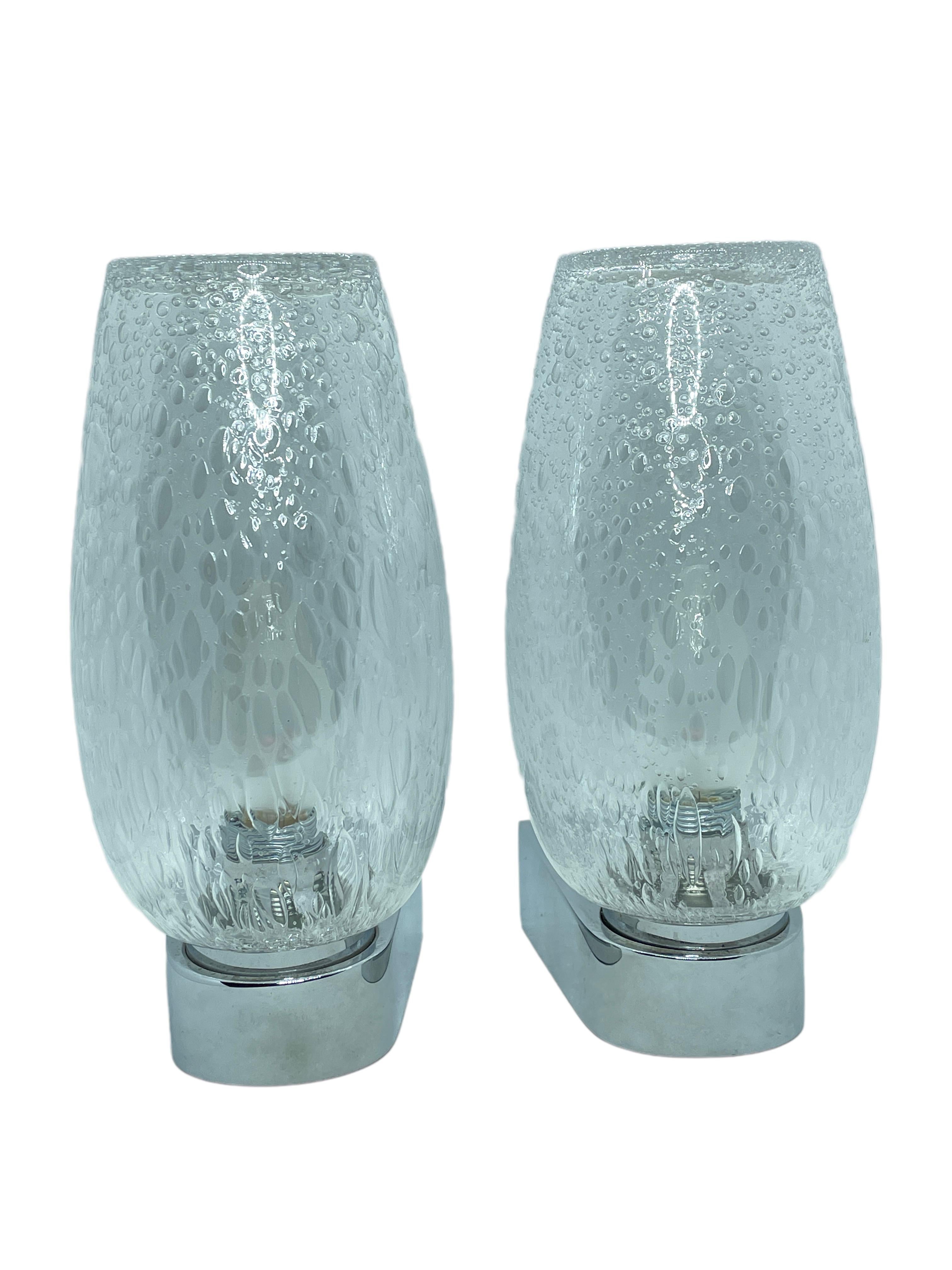 Pair of bubble glass sconces with chrome metal base. Made in Germany by Keuco Leuchten. Each fixture requires one European E14 / 110 Volt candelabra bulb, up to 40 watts. Nice chic design gives a real classy statement. Lightbulbs seen in the