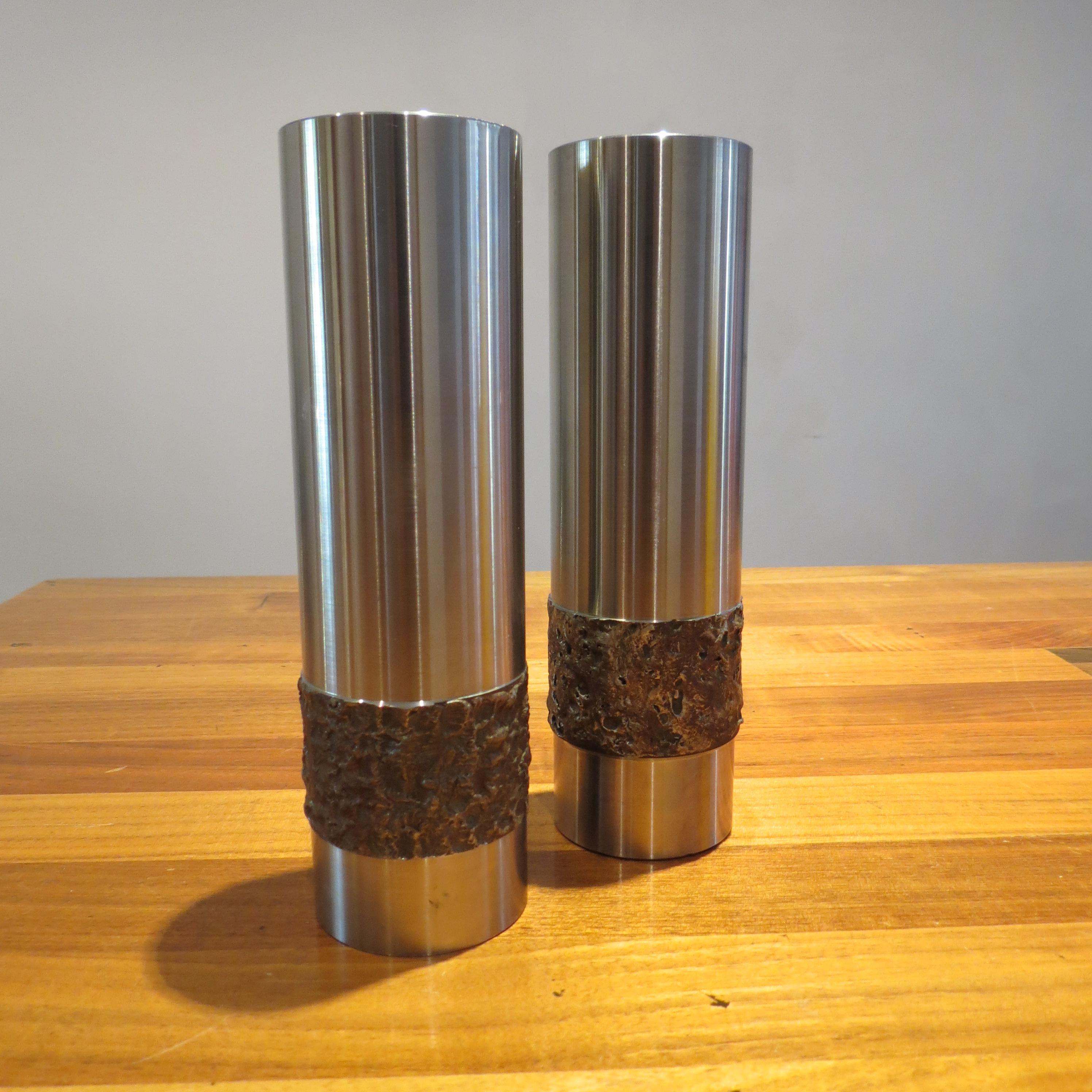 Pair of stainless steel vases in Brutalist form from the 1970s. 
Hand produced in Germany, turned stainless steel with decorative pattern. Very heavy good quality piece, could also be used as candleholders. 
 

The each measure 20.5 cm x 6 cm