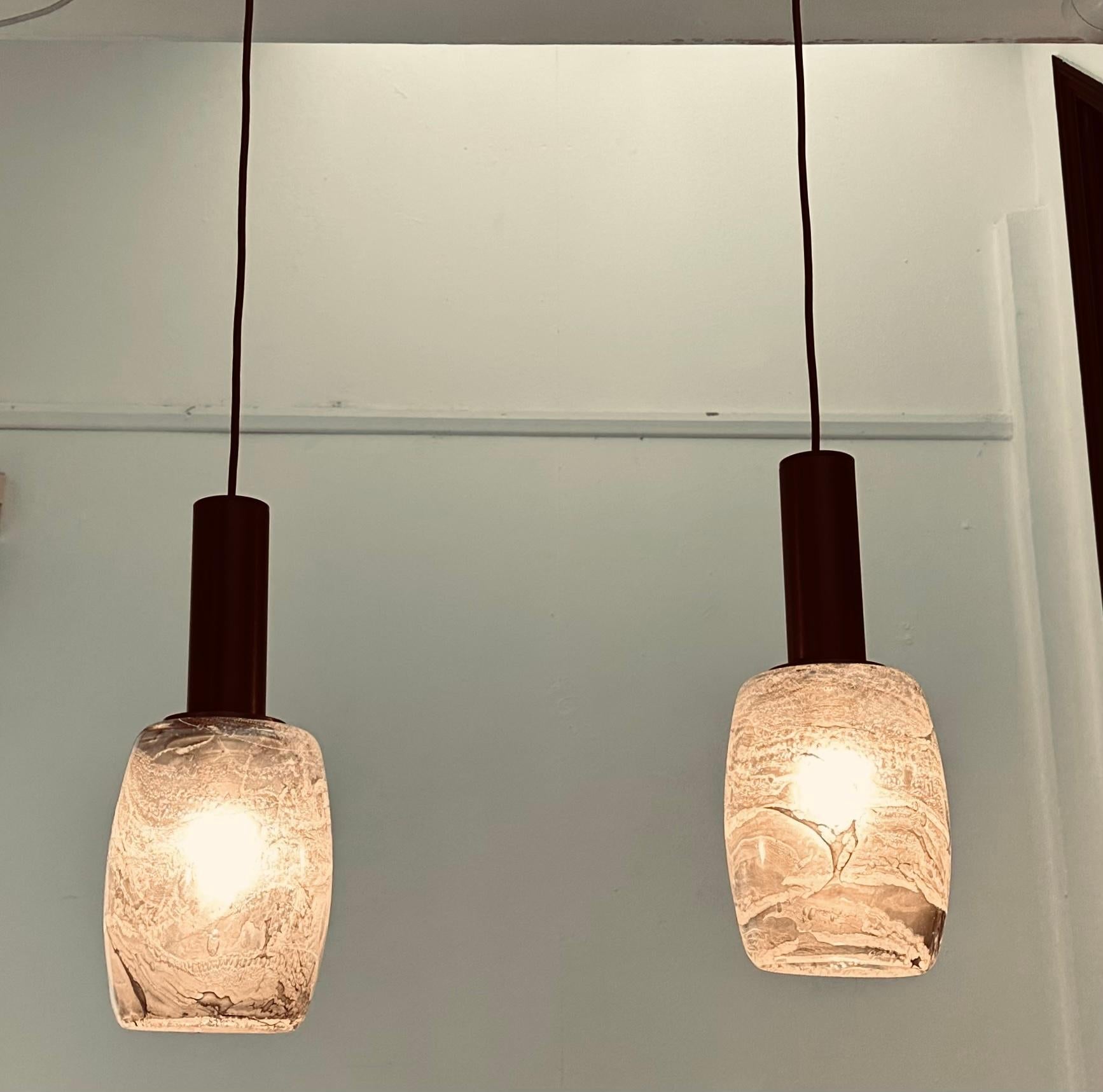 Pair of grey, white and black marbled effect hanging pendant ceiling lights manufactured in Germany by Peill & Putzler during the 1970s.  The thick hand blown glass shades with black metal fittings are suspended from height adjustable black wire