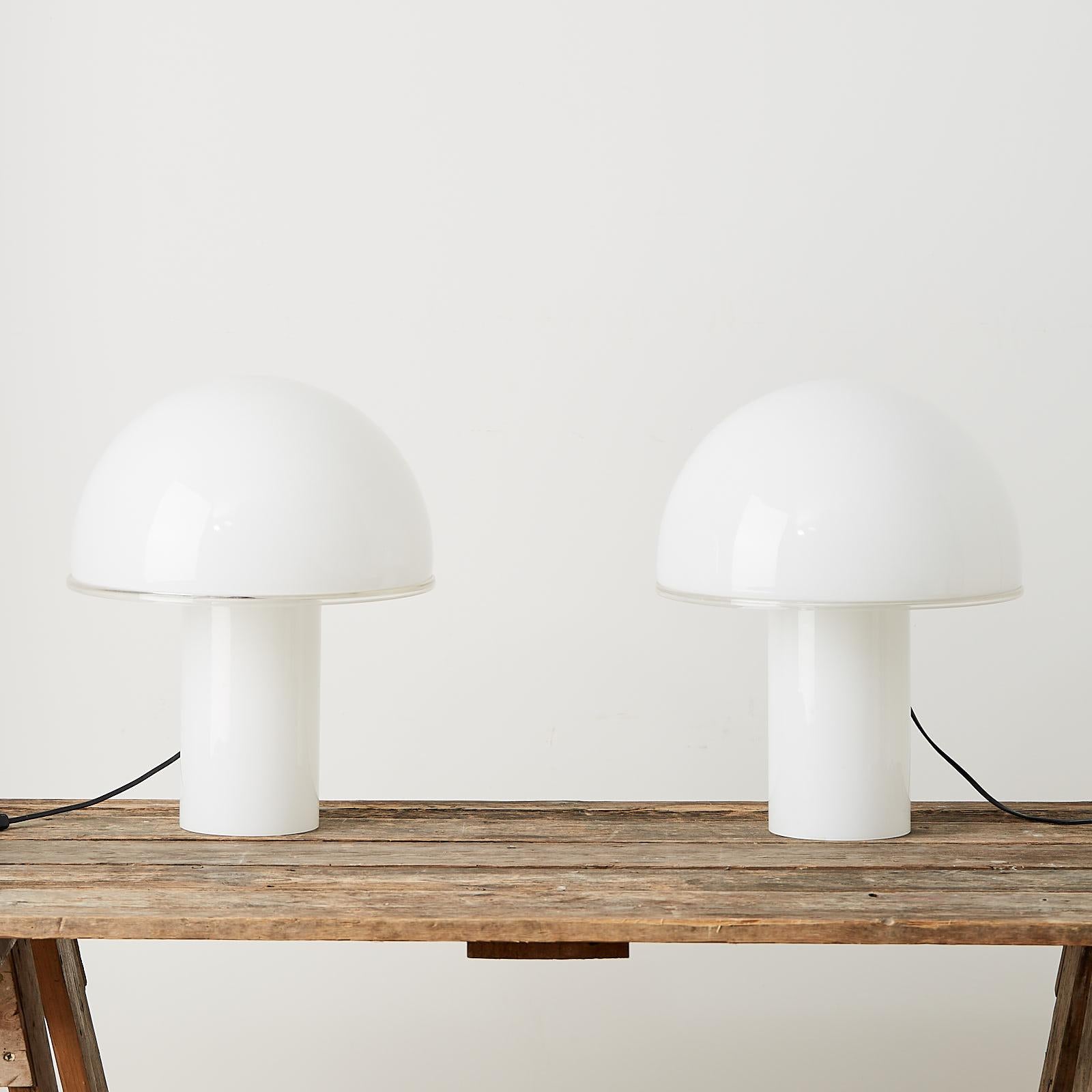 A pair of large Onfale table lamps designed in Italy by Luciano Vitosi in 1978 for Artemide, Italy. The lamps are made entirely of blown opaline glass.