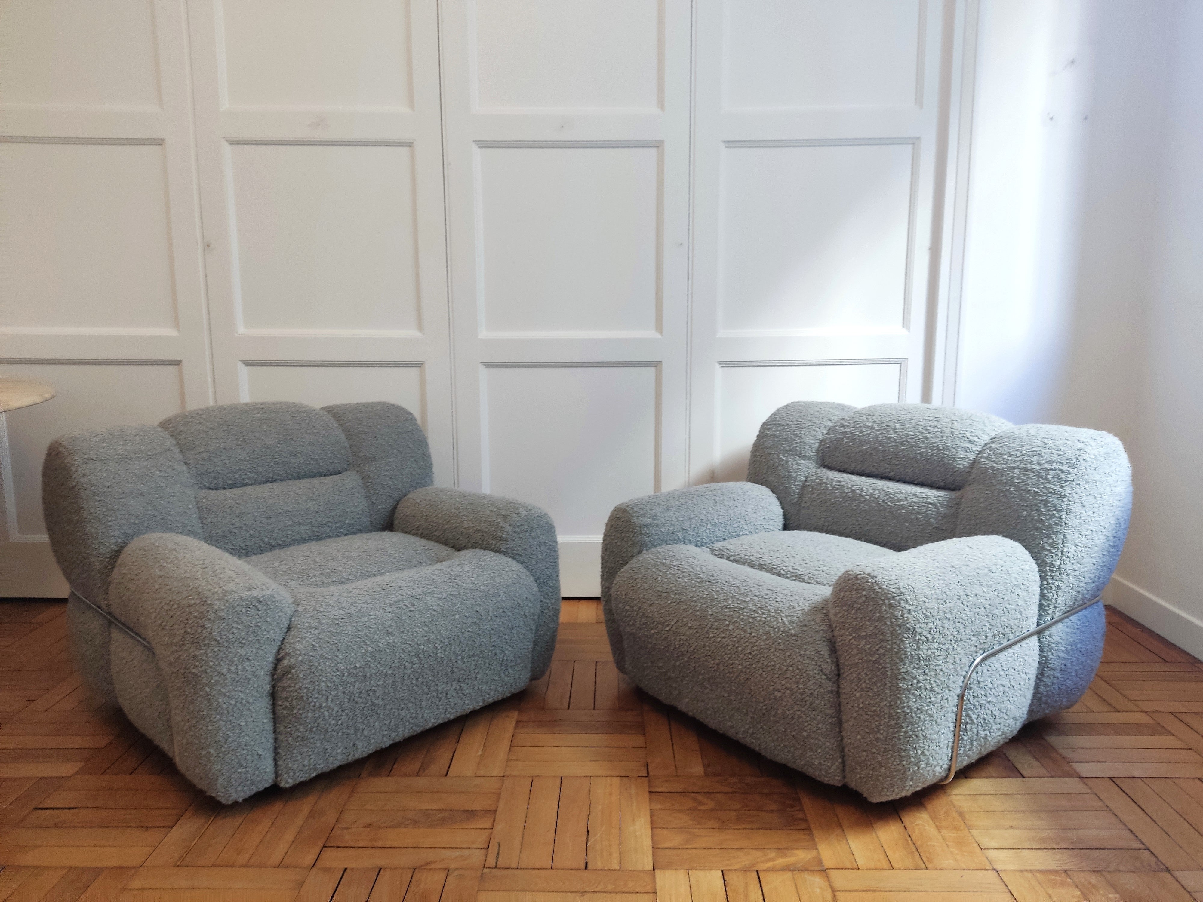 Ultra plush and comfortable pair of Italian 1970's lounge chairs. Freshly upholstered with chic grey bouclé. 
In good vintage condition.
These chairs will ship from France.
Price does not include packing, shipping nor possible customs duties related