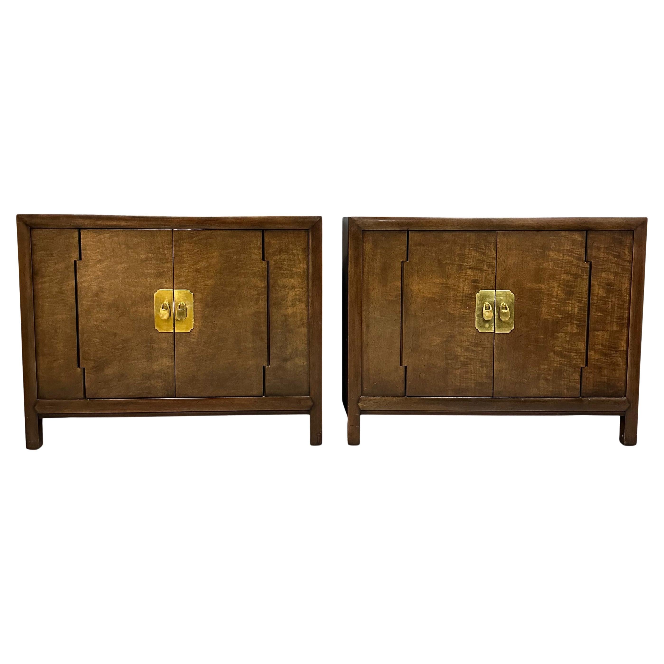 Wonderful pair of two door chests in fruitwood with brass accents. The doors have an unusual hinge configuration that open to reveal a single shelf. These chests can be utilized in many applications.