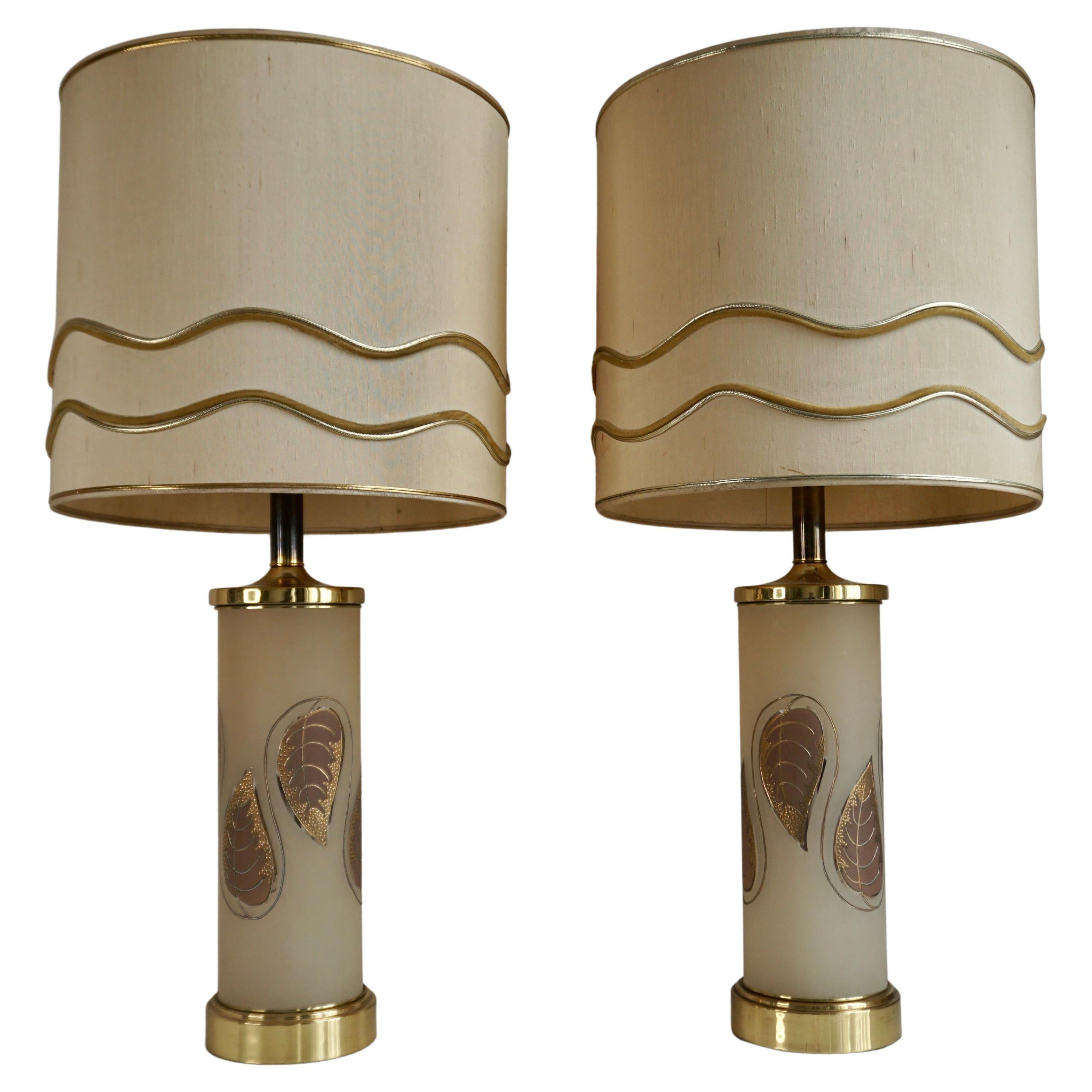 Pair of monumental table lamps created in the early 1970s in the style of Carl Falkenstein, Marbro and Rembrandt lighting. The ultimate in midcentury Hollywood Regency including original gold leaves and high quality construction and fittings.