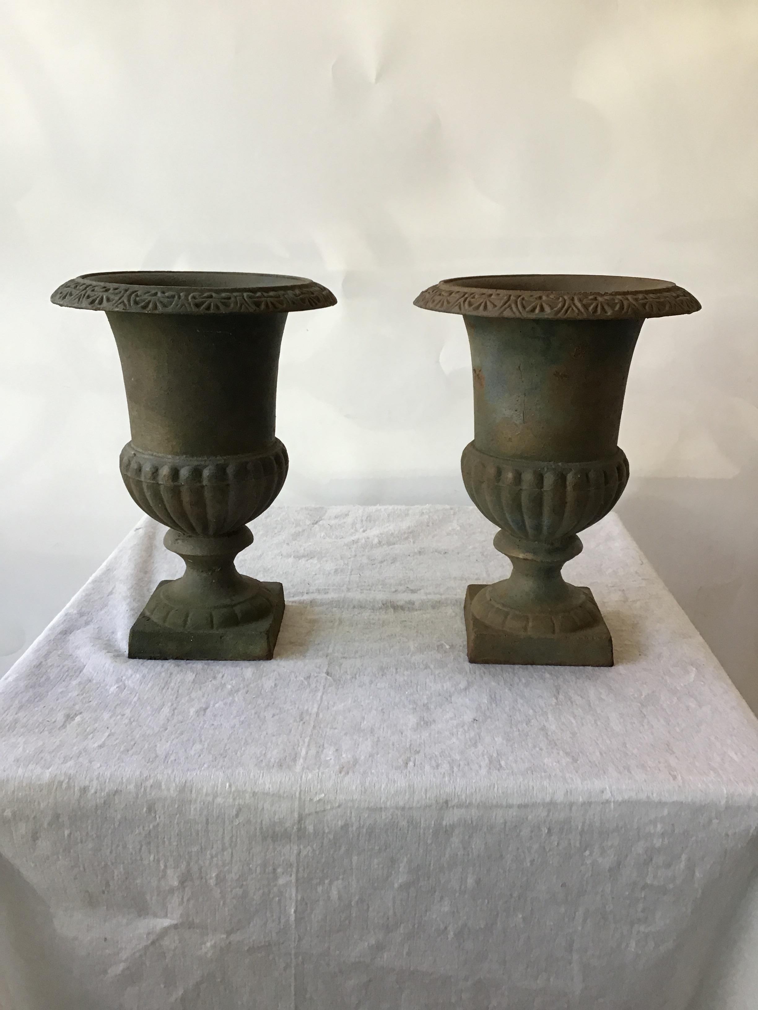 Pair of iron urns.