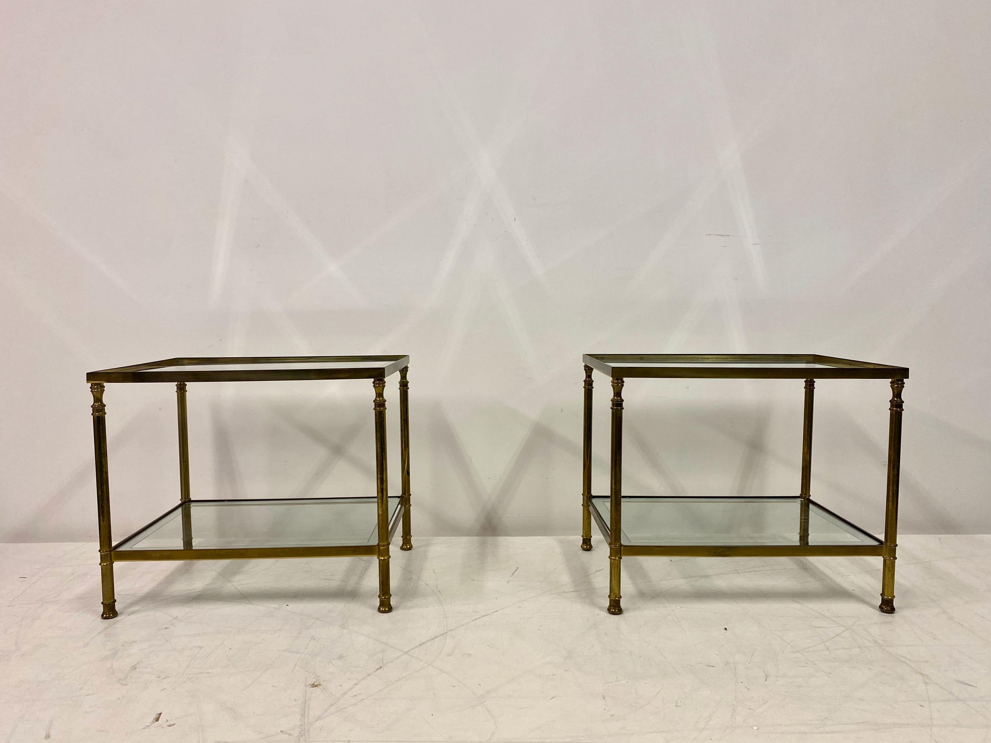 Pair of side tables.

Brass frame.

Heavy gauge frame.

Glass with mirrored edge.

1970s Italy.