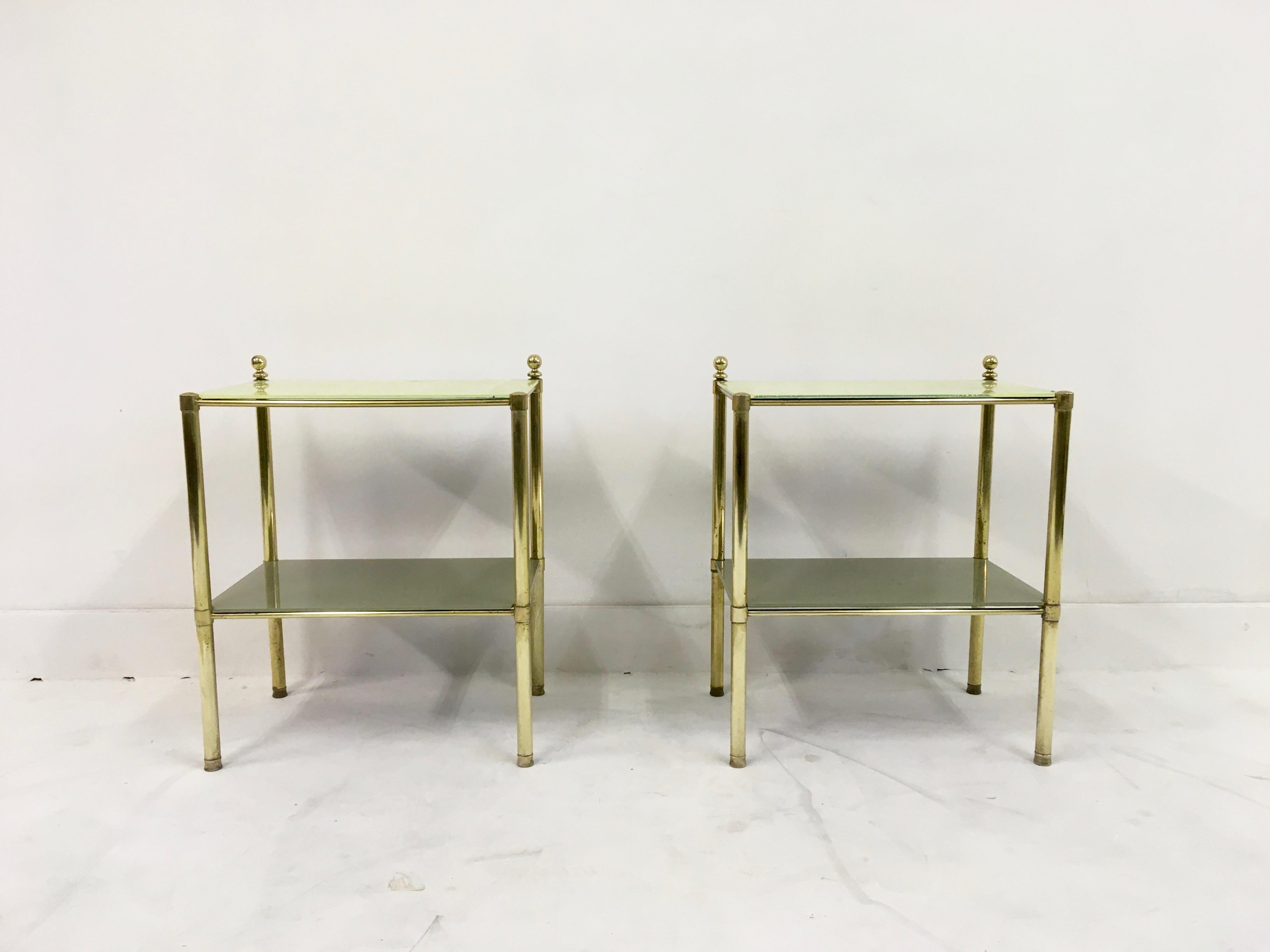 A pair of brass side tables

Or bedside tables

Yellow and grey glass

Two-tier

Italian, 1970s.
