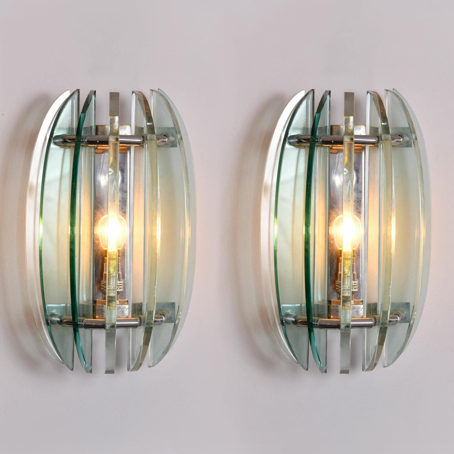 Pair of wall lights with alternating pale green and clear crystal glass pieces projecting out from chrome backplate.