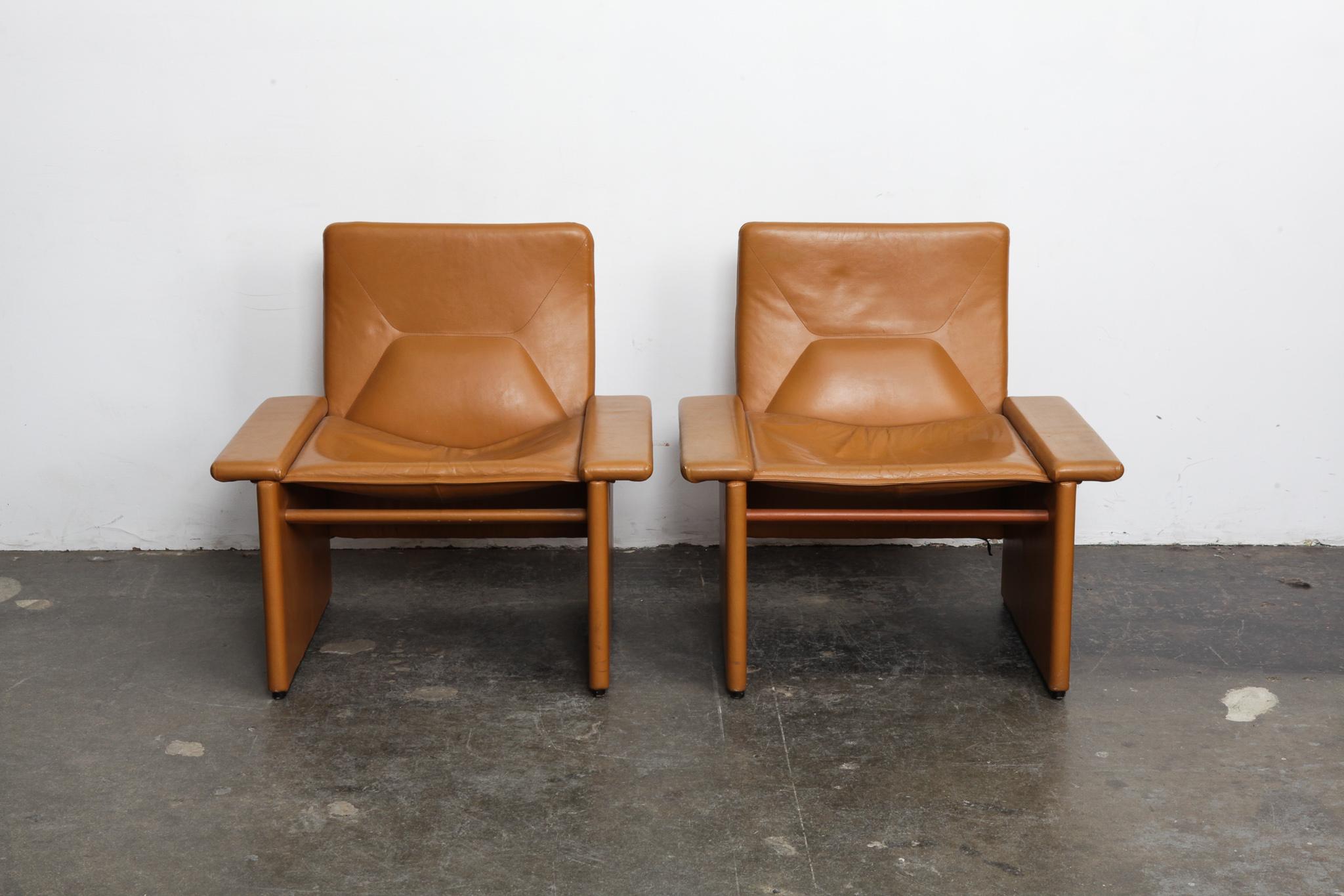 Pair of cognac original leather 1970s Italian lounge chairs with very straight lines, back cushion tufting and minimal patina. Very similar to designs by Tito Agnoli, but attribution not confirmed.