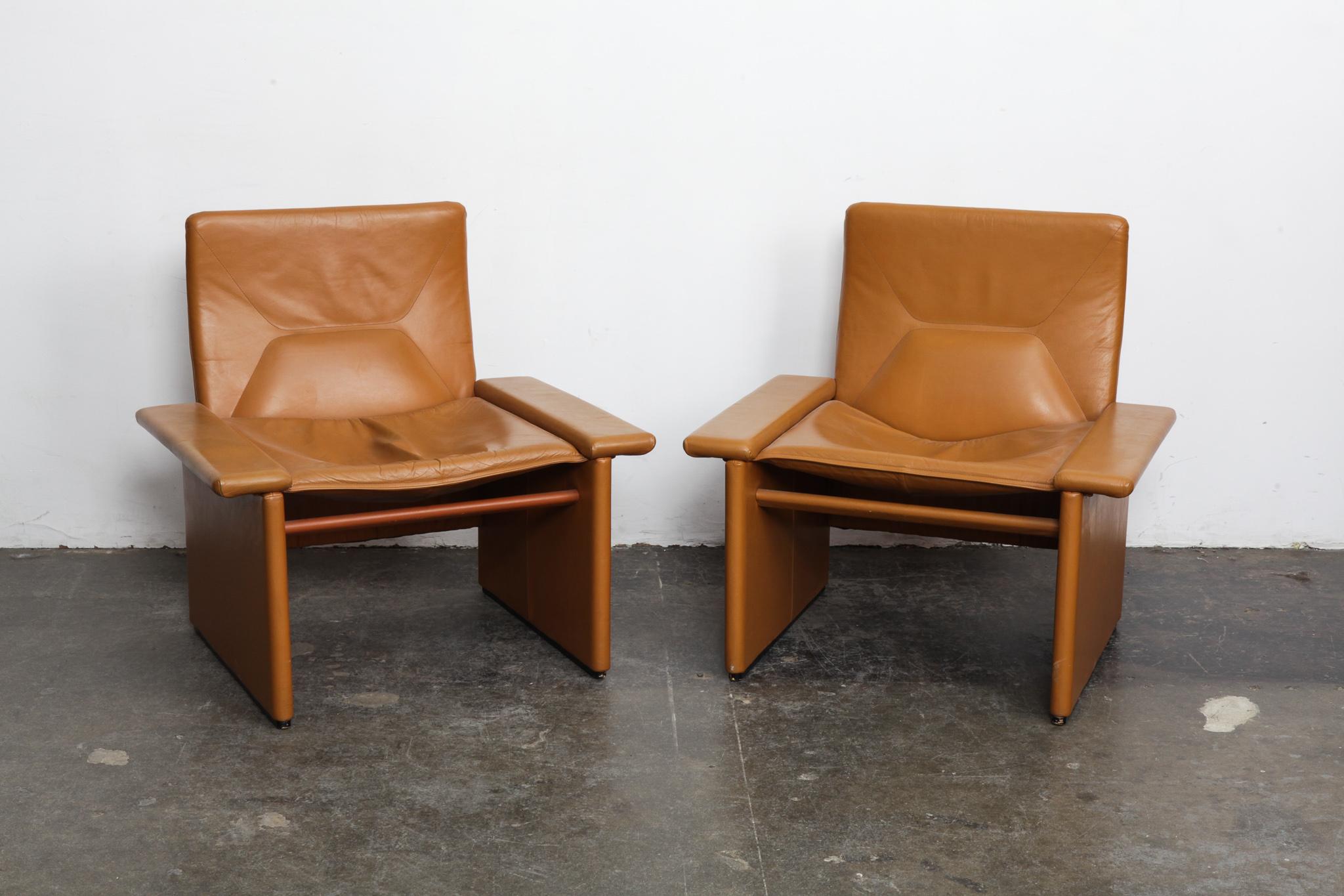 Pair of cognac original leather 1970s Italian lounge chairs with very straight lines, back cushion tufting and minimal patina. Very similar to designs by Tito Agnoli, but attribution not confirmed.