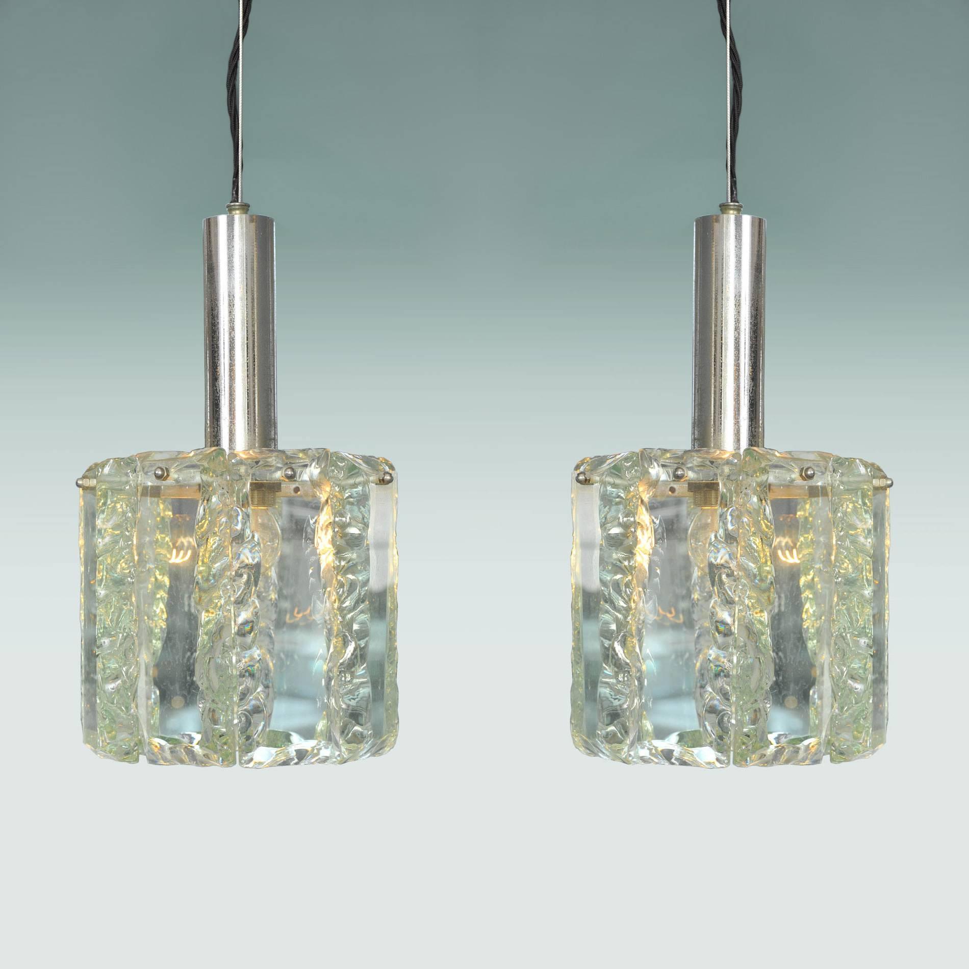 Fine pair of pendants with faceted Murano glass drops of very pale eau de nil forming a circular shade supported by their original chrome frames.