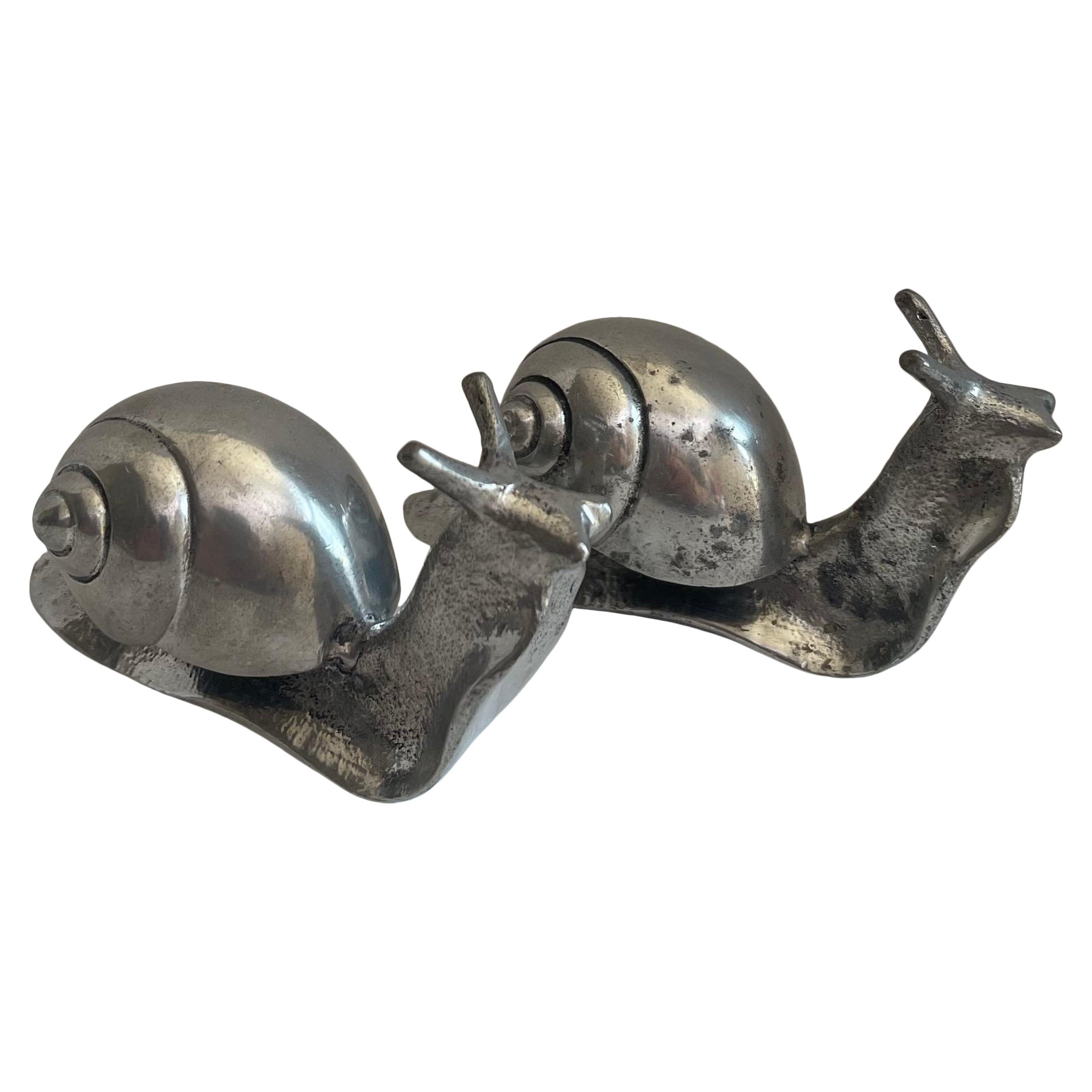 Coppia di statuette a forma di lumaca in argento degli anni Settanta