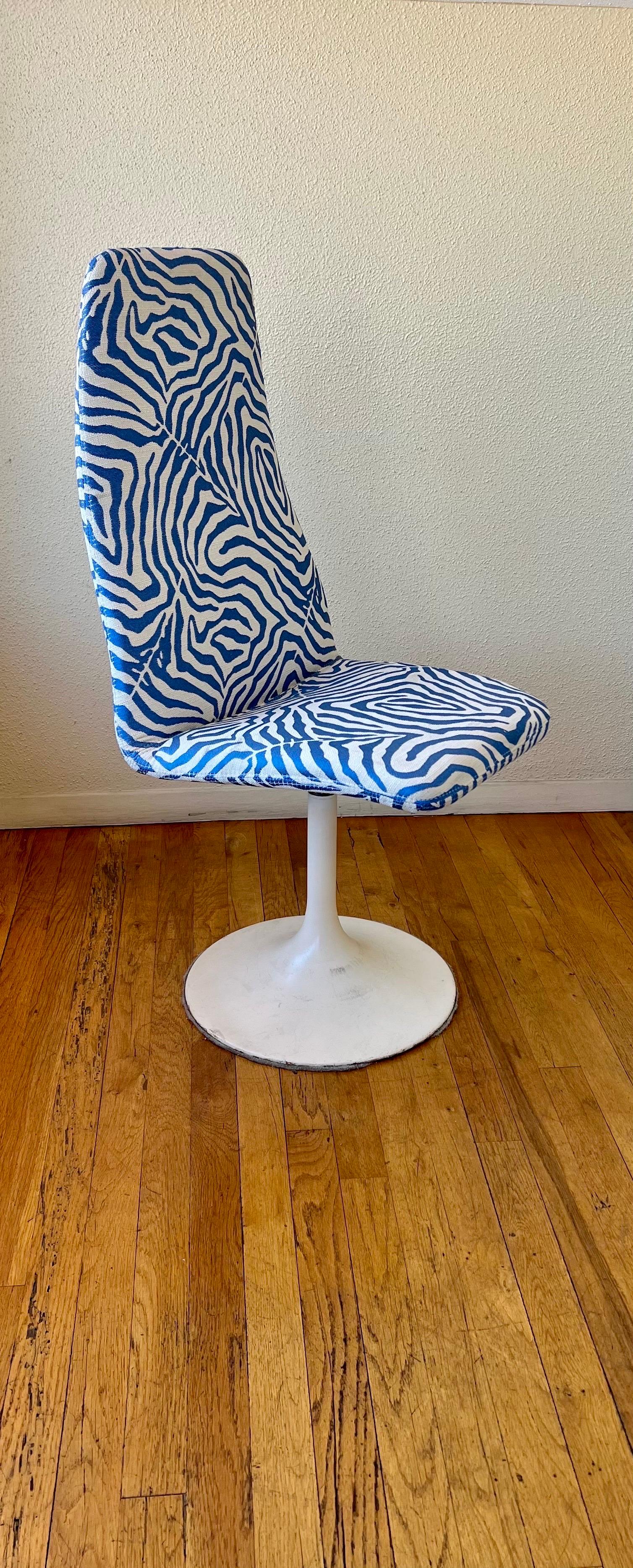 Striking tall back pair of chairs, with original zebra fabric print the chairs swivel and are in very clean condition.