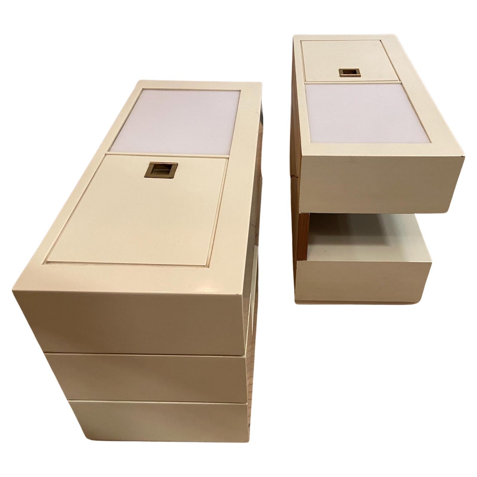 off white lacquered and wood modernist cabinets / night stands/ end tables ... with internal lights under a white acrylic cover. Switches in the recesses. A good modernist pair.