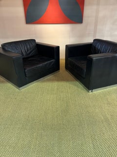 Pair of 1970's large dark blue leather armchairs on steel bases, by Durlet