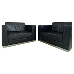 Pair of 1970's large dark blue leather armchairs on steel bases, by Durlet