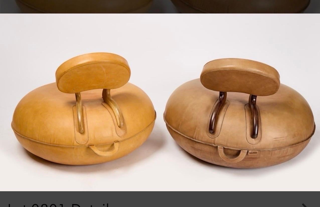 A pair of absolutely fabulous vintage 1970's leather covered inflatable rubber chairs, with hardwood accents. One bears a tag 