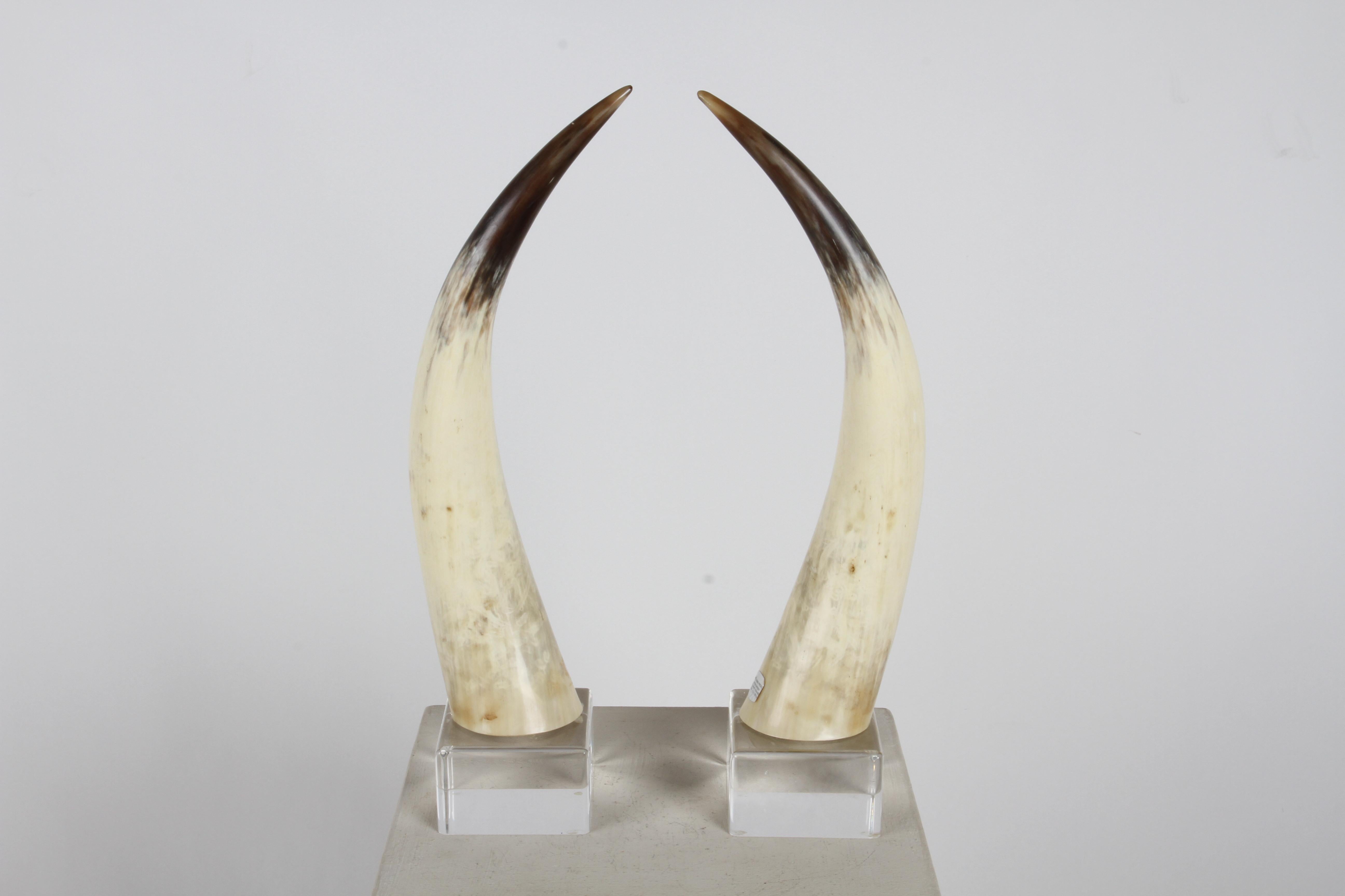 Fantastic and sculptural pair of natural steer horns on custom lucite bases circa 1970s, designed by Jean Roy Designs of California. Label. In fine condition, no issues.. In the style of Karl Springer. 