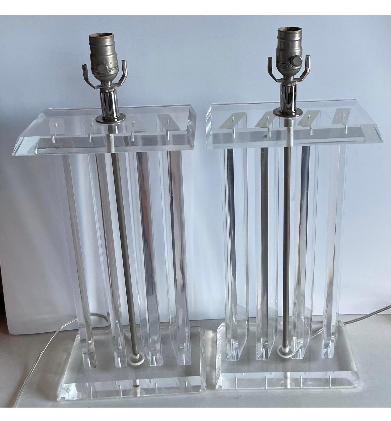 Pair of 1970s lucite column lamps. Recently rewired with chrome sockets. Each lamp takes one standard bulb (not included). Lampshades not included. 