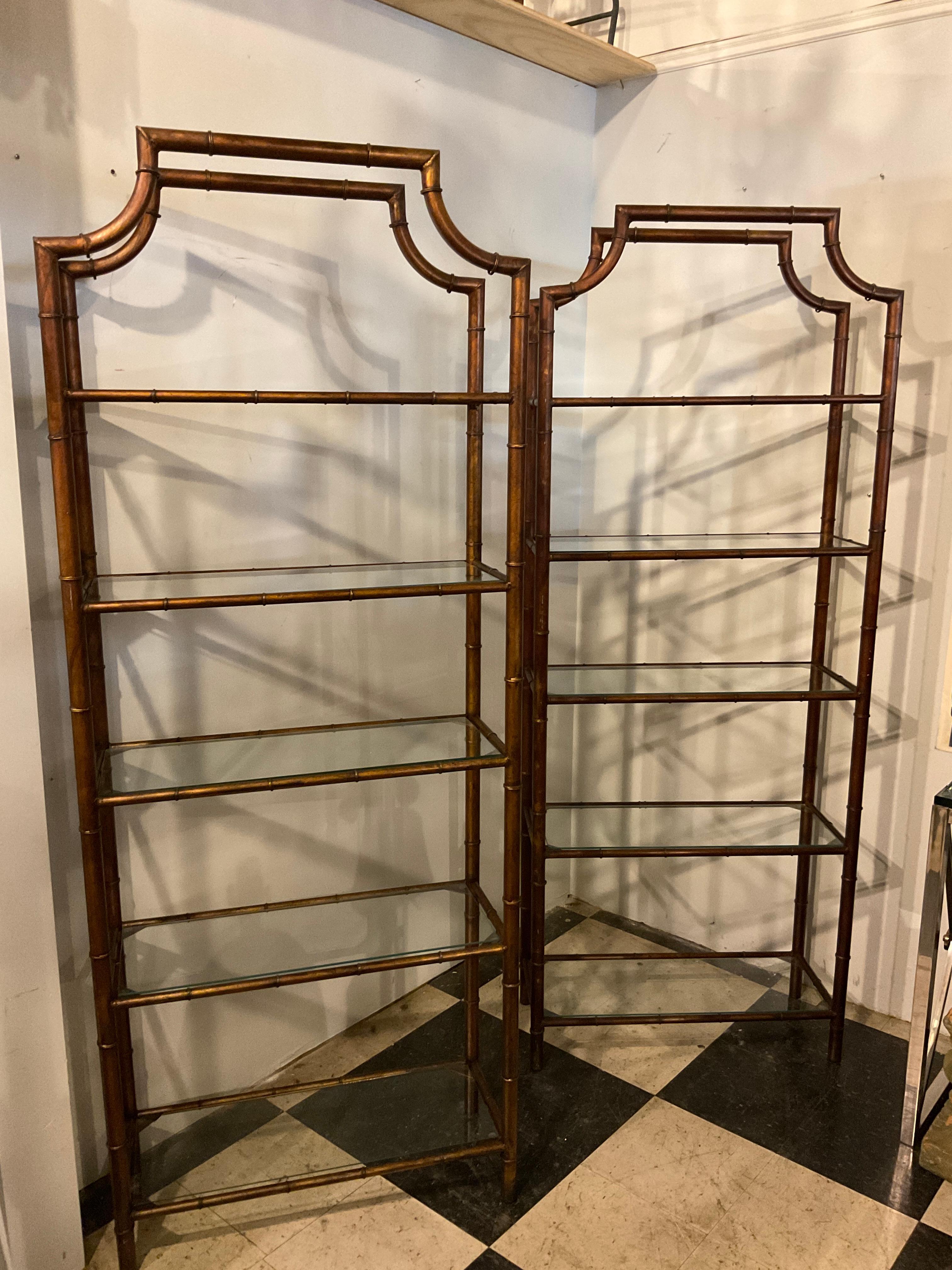 A pair of 1970s metal faux bamboo etageres with glass shelves. All the shelves have chips in the glass, they need to be replaced.