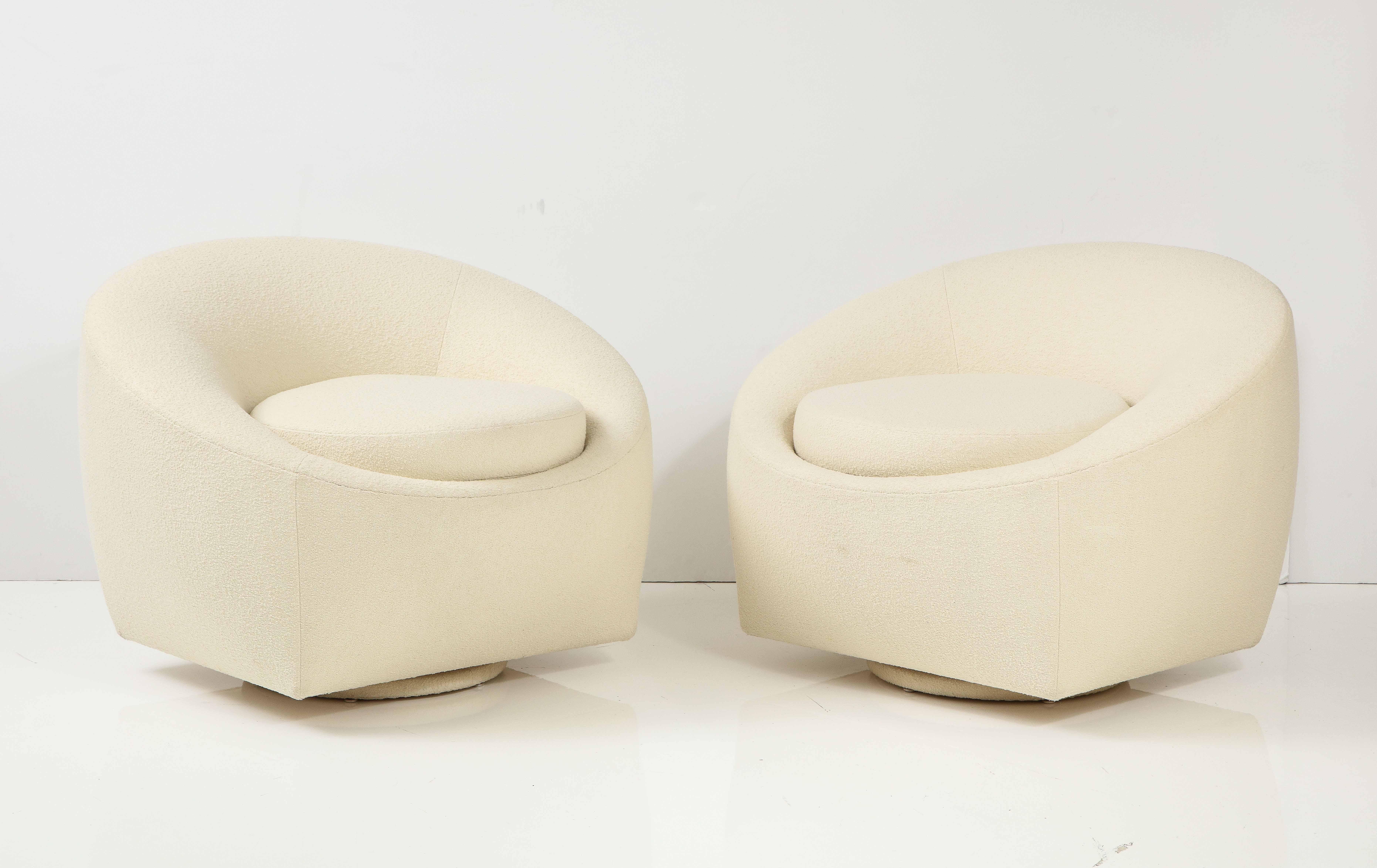 Pair of 1970s Modernist Swivel club chairs.
The chairs have been beautifully reupholstered in Knoll Ivory bouclé fabric and sit on swivel bases.