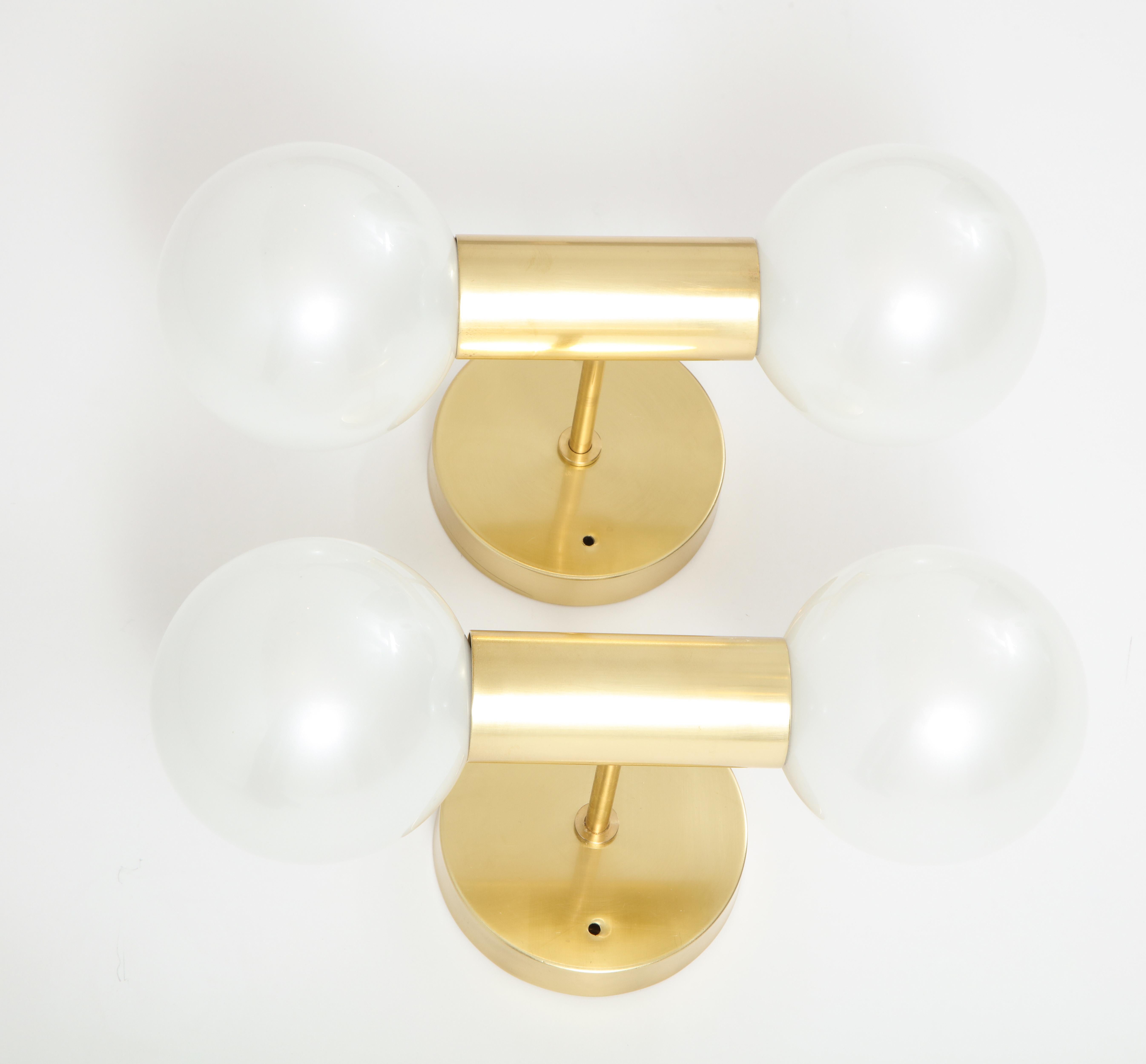 Pair of 1970s polished brass Sputnik style sconces by Motoko Ishii for Staff.
The polished brass mounts have been newly rewired and each holds
2 x 40 watt candelabra bulbs which are covered by large pearlized globes.