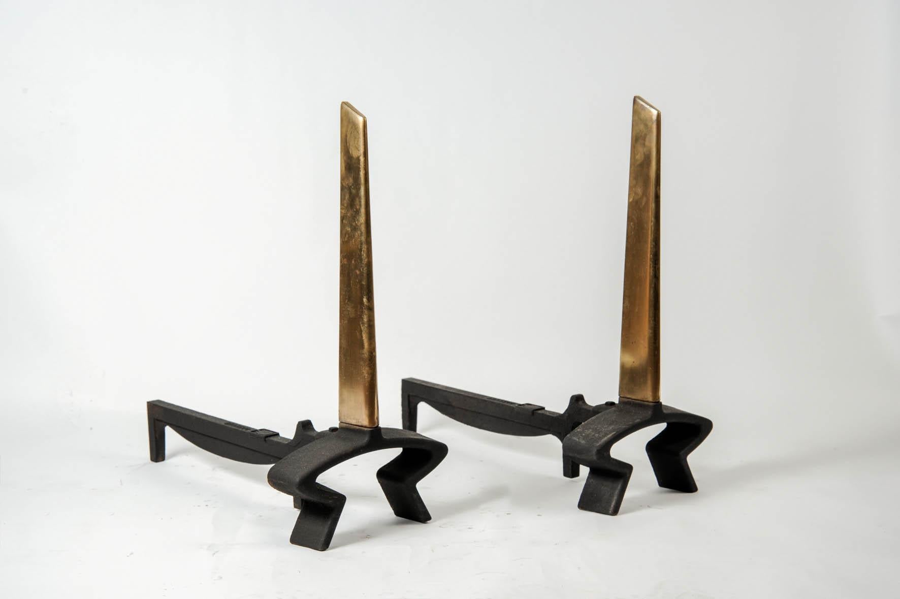 Pair of andirons in cast iron and polished bronze.