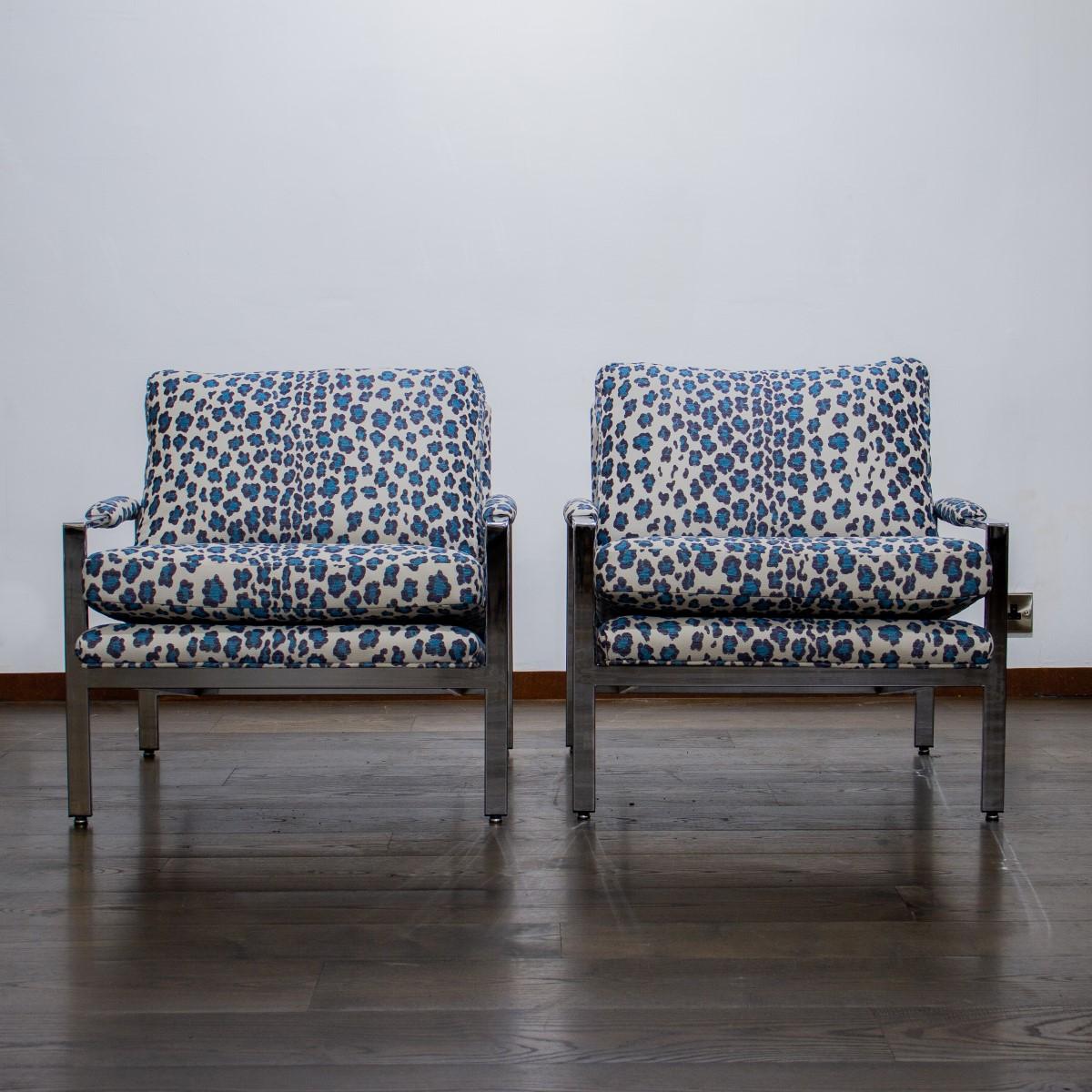 A pair of nickel framed armchairs designed by Milo Baughman, with sloping arms and seat upholstered in a modern blue leopard print fabric, 1970s.

Milo Baughman Design Inc was established in 1947. In 1948 he helped create the California Modern