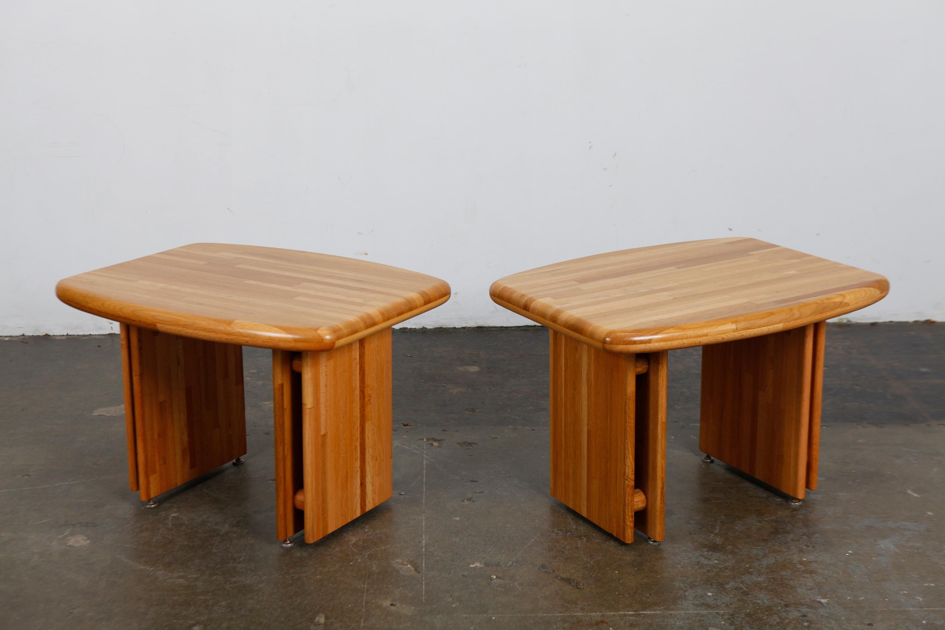 Pair of solid oak trestle leg end tables with a surfboard shaped top, attributed to Lou Hodges, USA, 1970s. Newly refinished in matte lacquer.