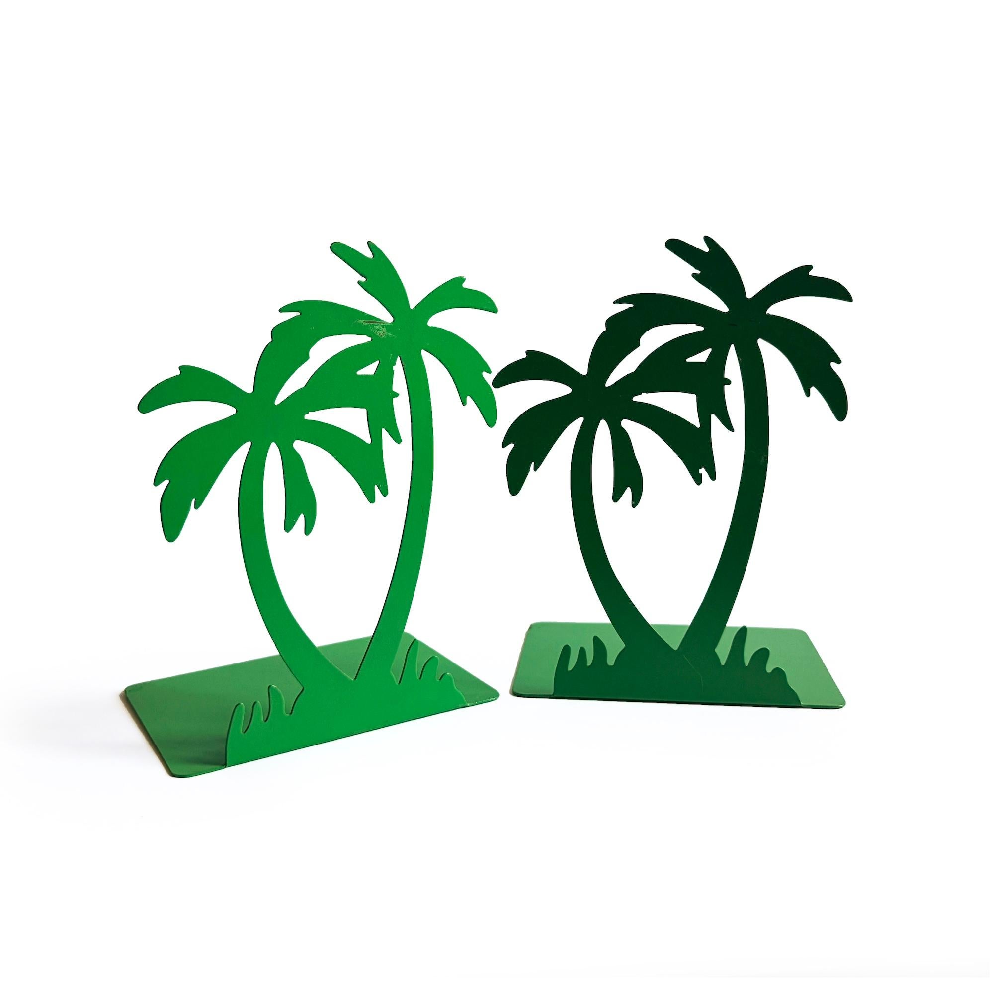 A charming 1970s tropical-inspired pair of palm tree bookends designed by Randall Schwartz for Moxie.  This pair  features detailed palm tree silhouettes crafted from metal with a green enamel. 

In good vintage condition with wear consistent with