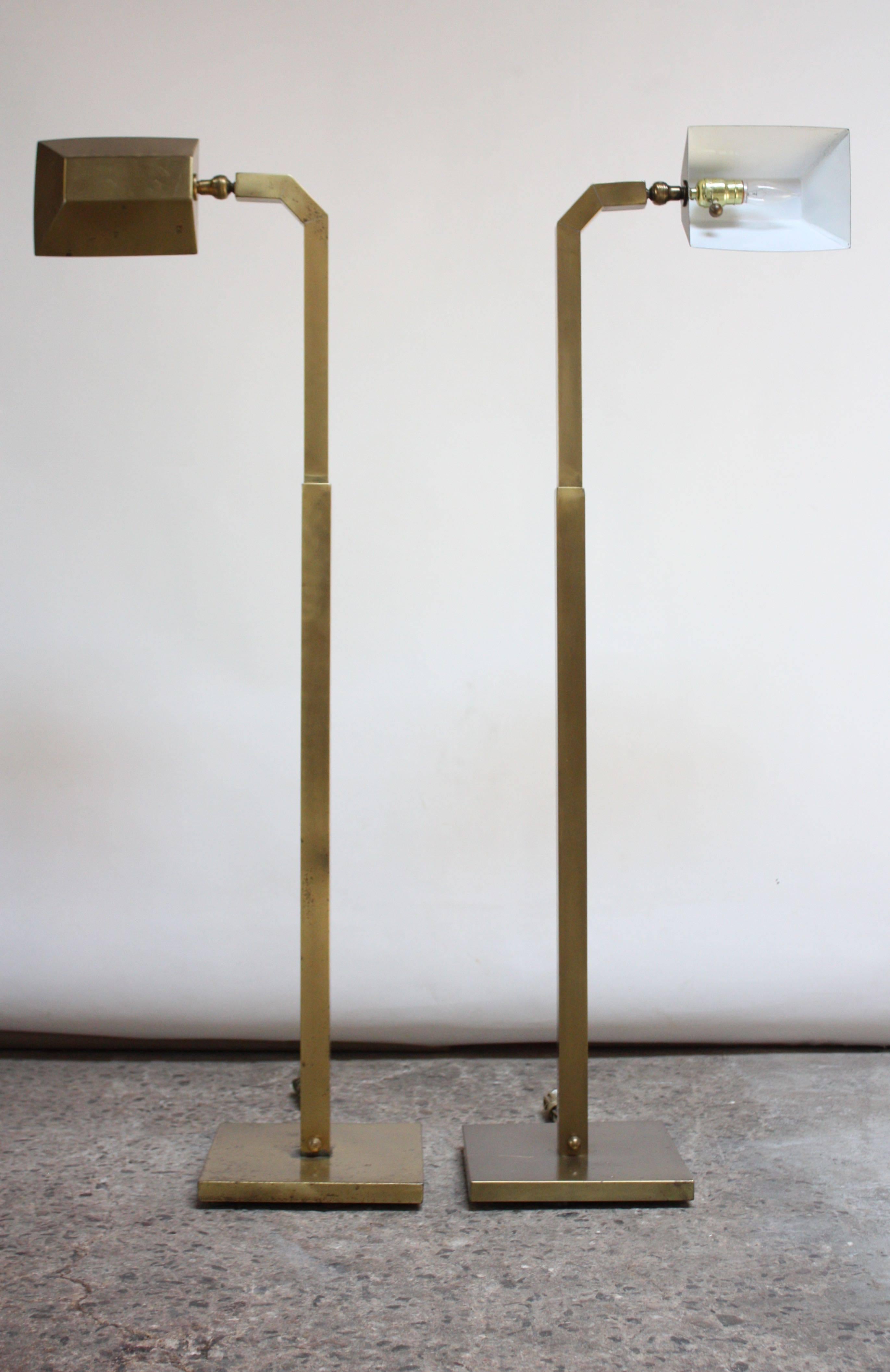 These floor lamps were designed by Chapman in the 1970s, combining Industrial and Modern Design. Composed entirely of brass, these lamps also feature the signature bronze finish and dimmer 'ball' knob with uniquely thick / wide shades. The shade is
