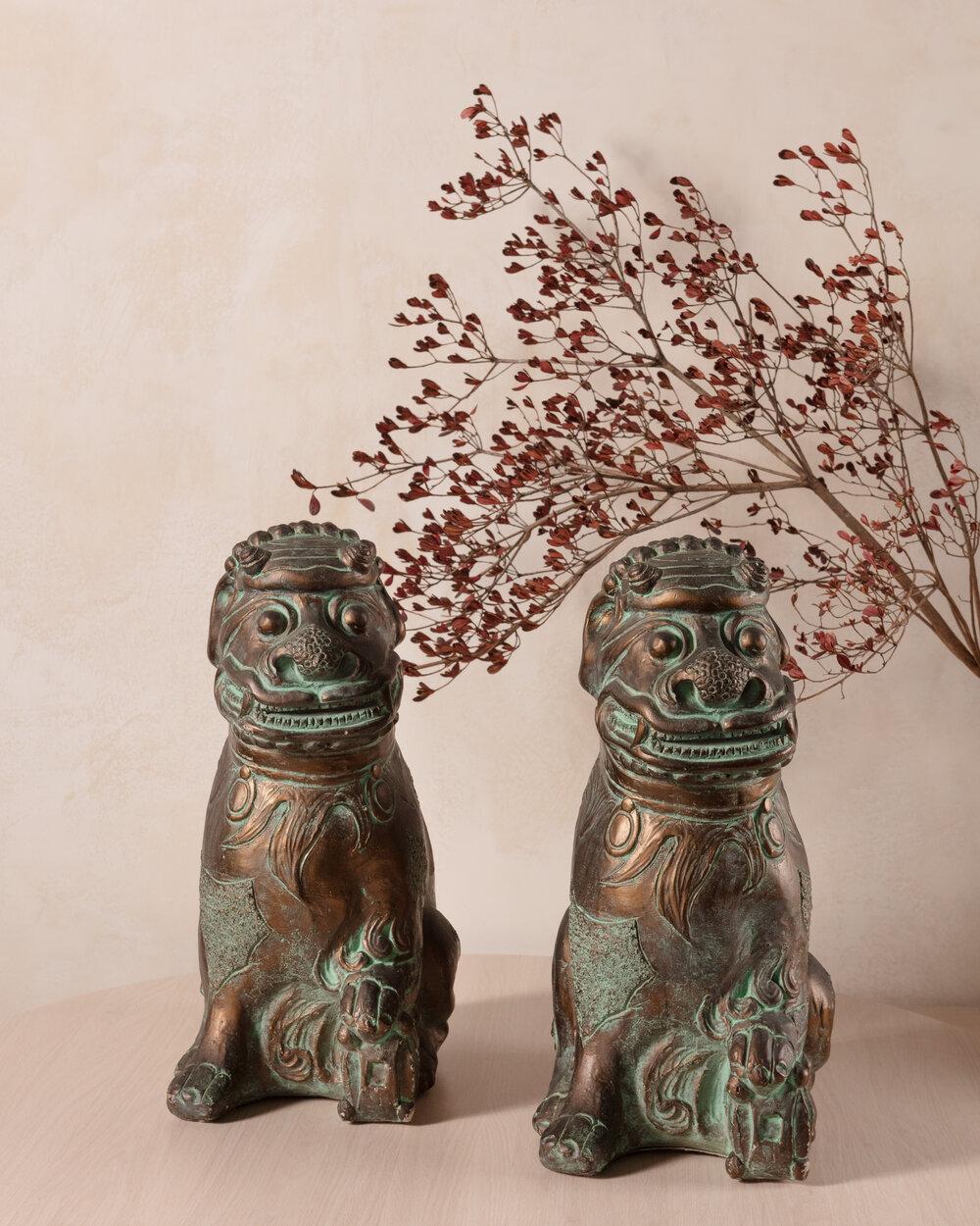 A substantial pair of 1970s plaster foo dogs sourced from a South Florida estate. Featuring fantastic details and a hand painted patina.