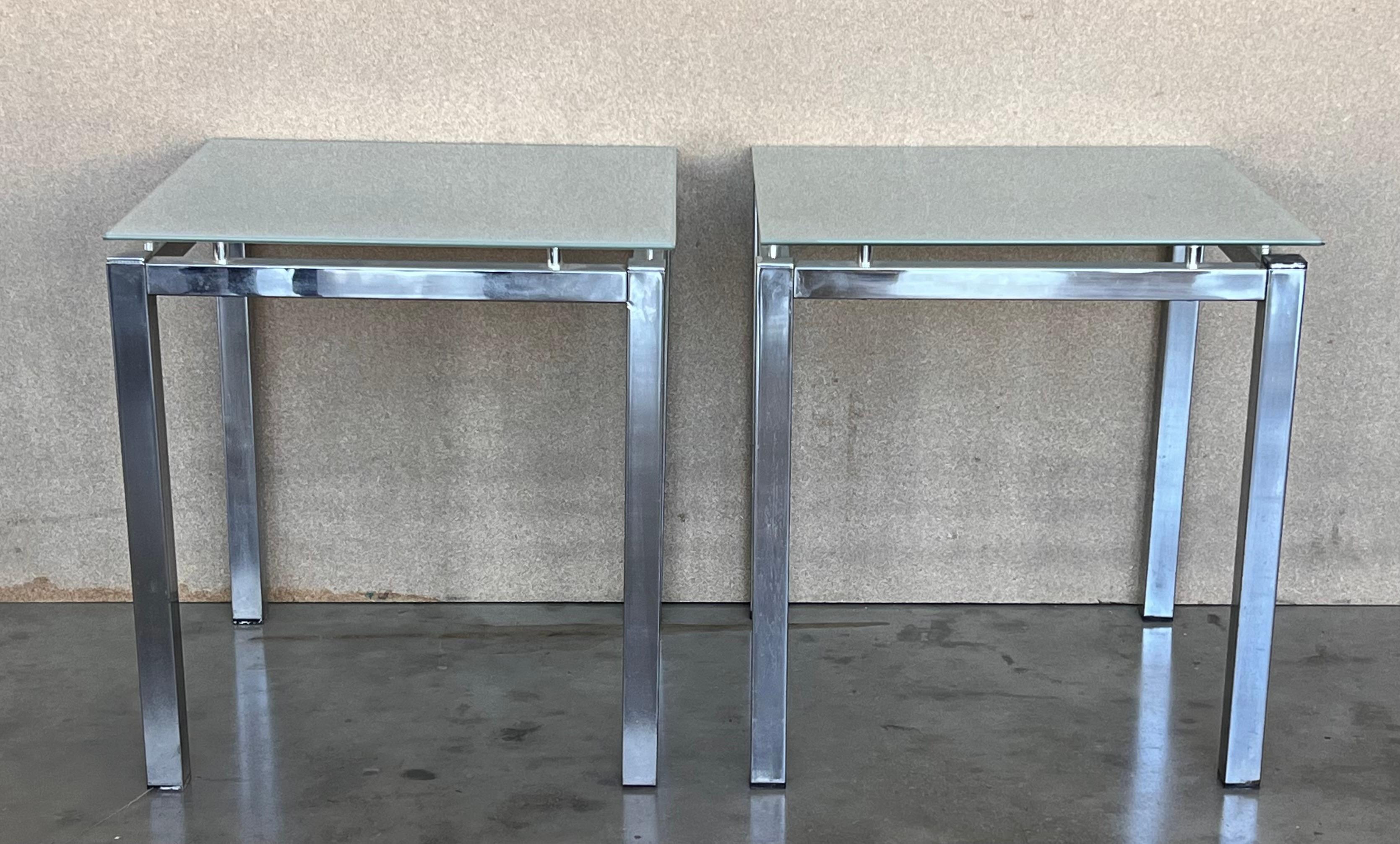 Introduce a dash of the 1970s to your living space with our pair of Postmodern tubular chrome and glass end tables. Exhibiting a sleek, minimalistic design, these tables feature square base frames, bolstered by tubular chrome legs, and are topped