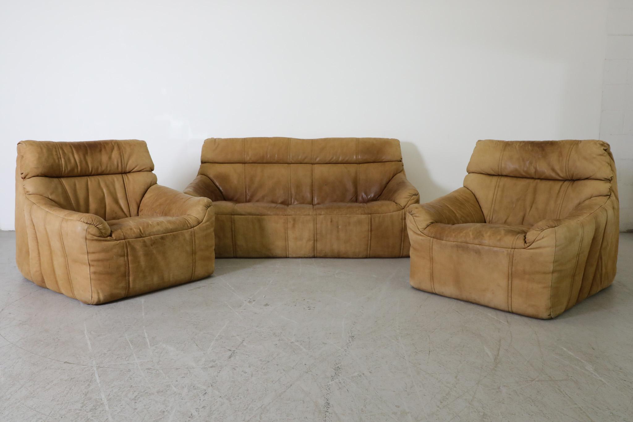 Pair of Mid-Century, nubuck leather, lounge chairs by German furniture manufacturer Rolf Benz. Designed and made in the 1970s. A handsome chair set with inviting soft form frames covered with durable, leather upholstery. Has beautiful, well-loved
