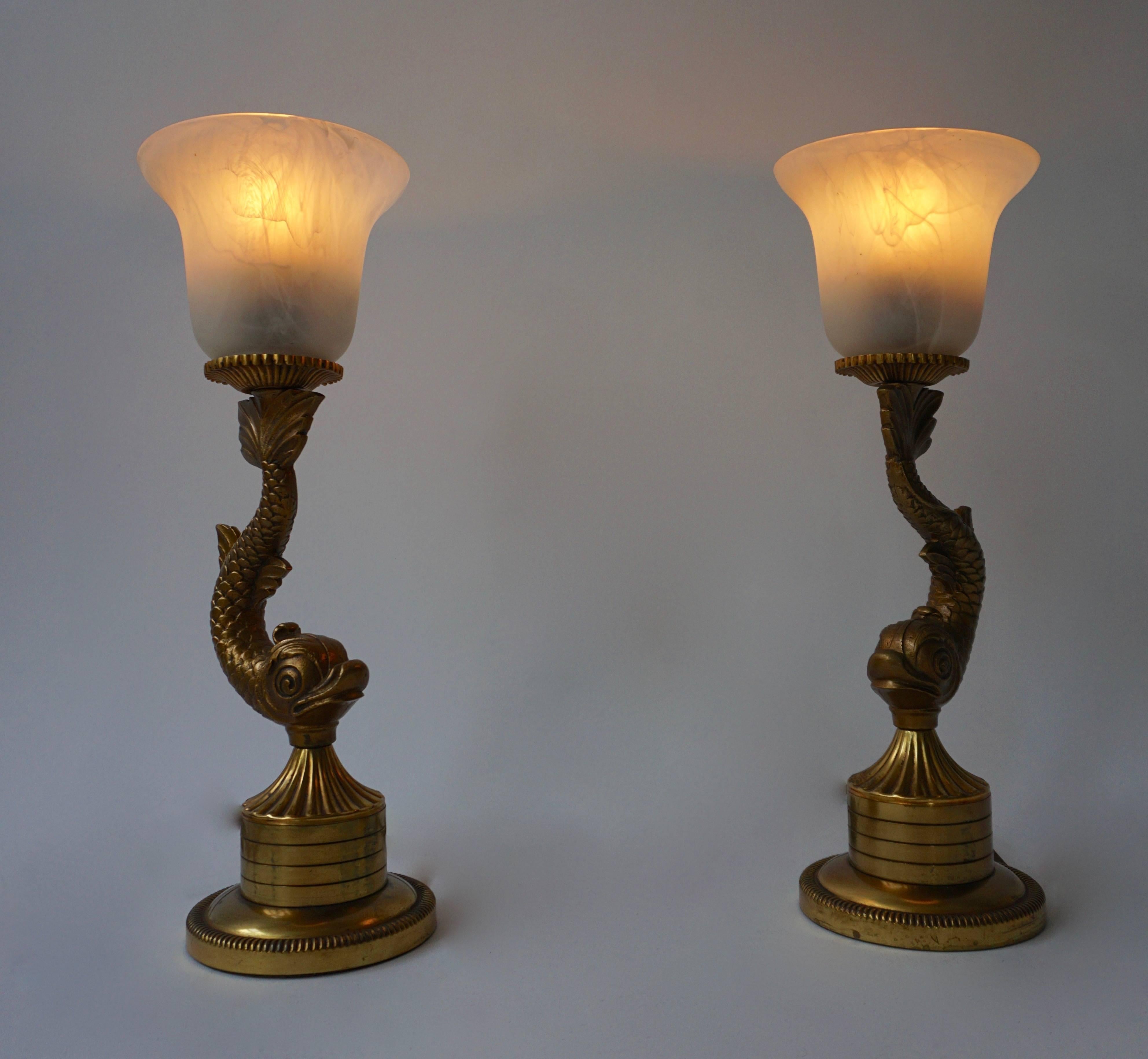 Pair of large 1970s table lamps designed and manufactured in France. 

Decorative brass gilt fish design with black glass lampshades.