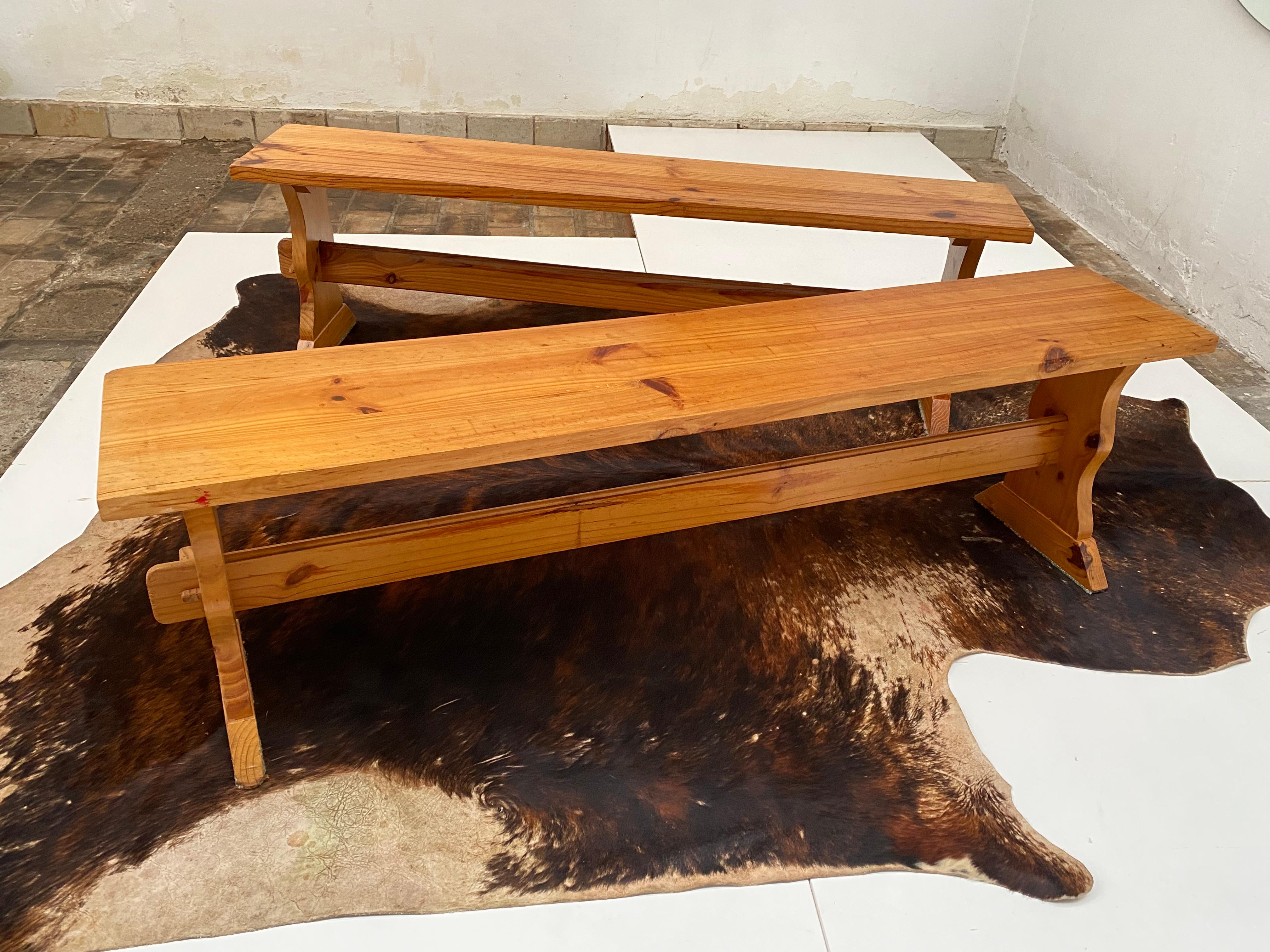 Pair of rustic solid pinewood benches from the 1970's

Beautiful patinated appearance and very functional 

The Benches can be flat packed for volume saving low cost shipping 

Solid construction 